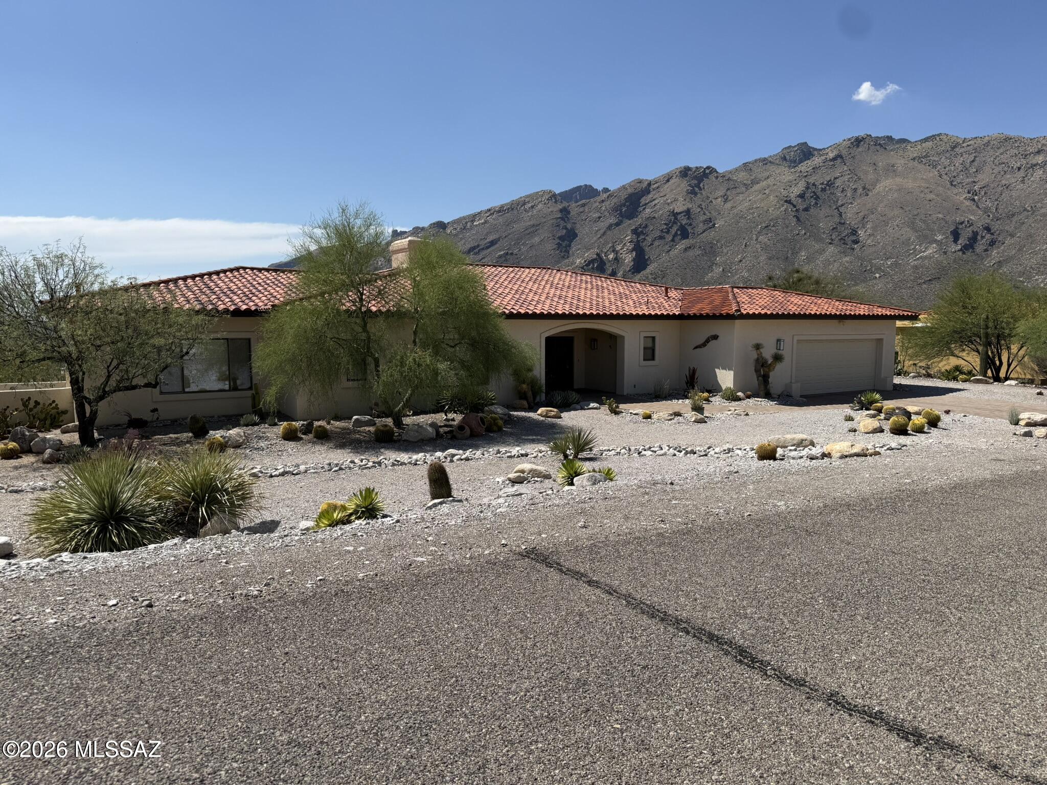 Located in the Alta Vista subdivision, this custom home offers breathtaking, unobstructed panoramic views of the Catalina Mountains and sparkling city lights. The welcoming foyer opens into an expansive living room highlighted by massive windows and a fireplace with a custom mantel, which flows seamlessly into a formal dining room perfect for entertaining! The kitchen boasts granite countertops, dual ovens, pull-out pantry shelves, oak cabinetry, and a breakfast nook. The Owners Suite includes direct patio access, dual walk-in closets, a jetted tub, separate walk-in shower, and double vanities. Two additional bedrooms with a bathroom in between with walk in shower and tub. Spacious wrap-around patio covered deck offers a close-up view of the Catalina Mountains. Outdoor Sauna, too!
