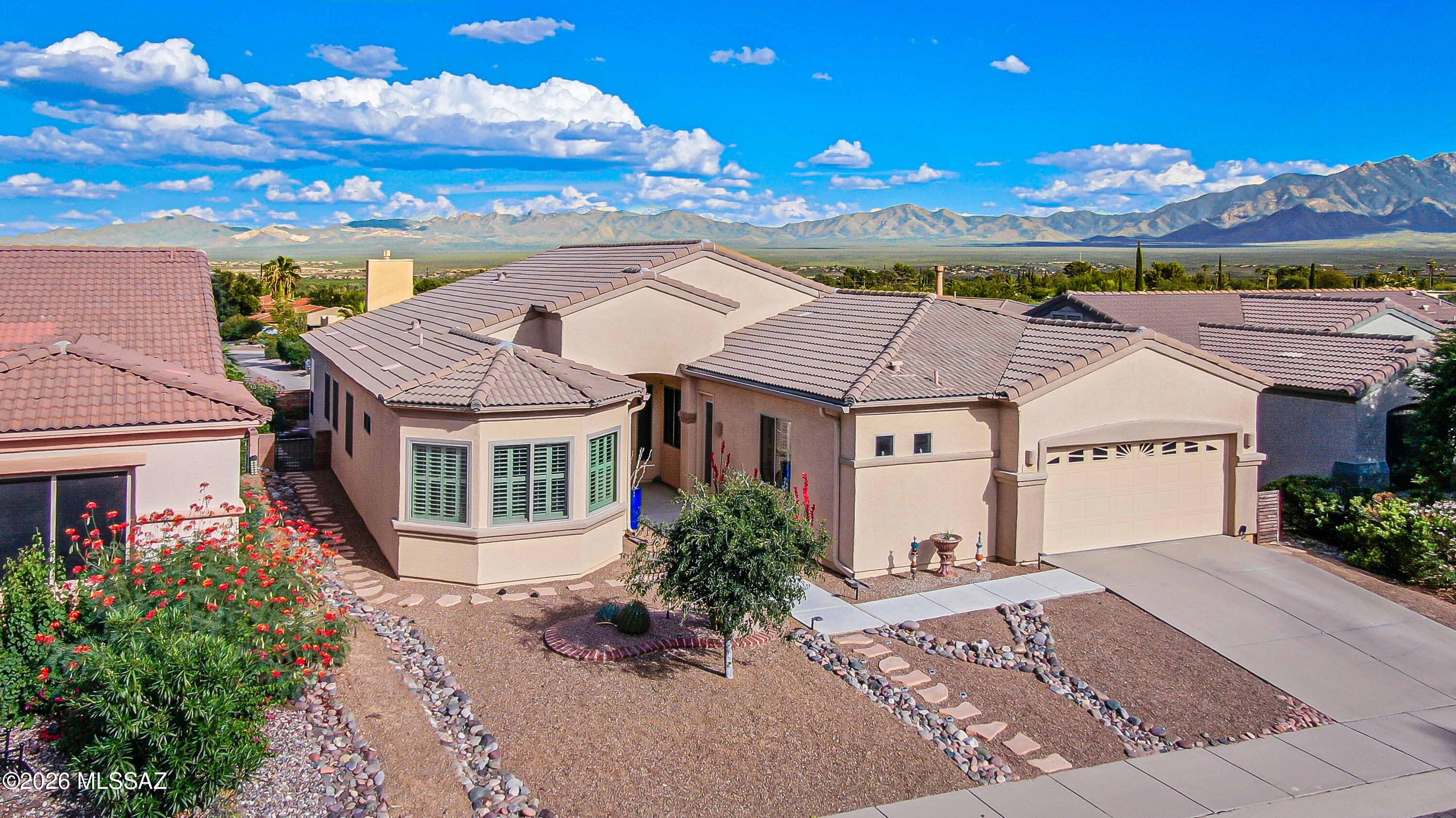 Turnkey and beautifully updated, this inviting Green Valley home showcases panoramic Santa Rita Mountain views! Owned solar provides the added benefit of super-low electric bills. Recent improvements include new flooring throughout most of the home, Andersen windows in several rooms, beautifully refaced kitchen cabinetry, new shades and appliances less than 3 years old. The primary suite has new paint and flooring, while the casita features new paint & a remodeled bath--perfect for guests or a private retreat. The formal living room is currently enjoyed as a game room with pool table, highlighting the home's flexible floor plan. With generous living spaces, a 2-car garage, extensive updates and spectacular mountain views, this home is truly move-in ready!