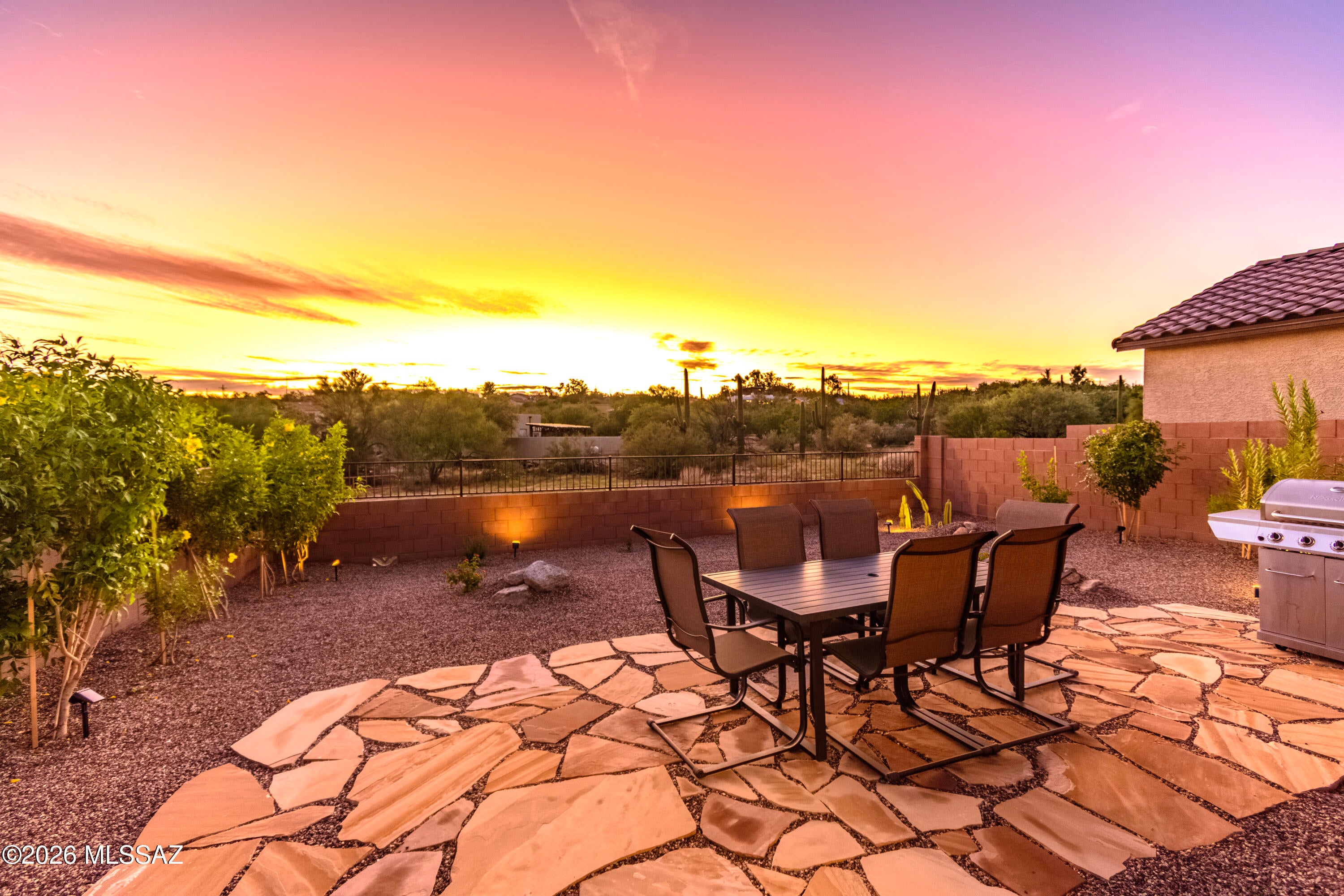 Breathtaking Sunset Views & True Turnkey Perfection in Northwest Tucson! Skip the wait and hassles of new construction! Built just over 2.5 years ago, this immaculately maintained, near-perfect 3-bedroom, 2-bathroom gem sits on a highly coveted, premium view lot with absolutely no neighbors behind. Experience legendary Arizona sunsets right from your own backyard oasis. The Highlights you'll love: -Relax under the desert sky on your massive 250 sq. ft. custom flagstone patio. -Move right in without spending a dime on day-one essentials. The home comes completely outfitted with custom window coverings, all major appliances, and ceiling fans with lights in the LR and each bedroom. -Enjoy outdoor accent lighting, both the front and back, and the energy efficiency of a nearly-new home