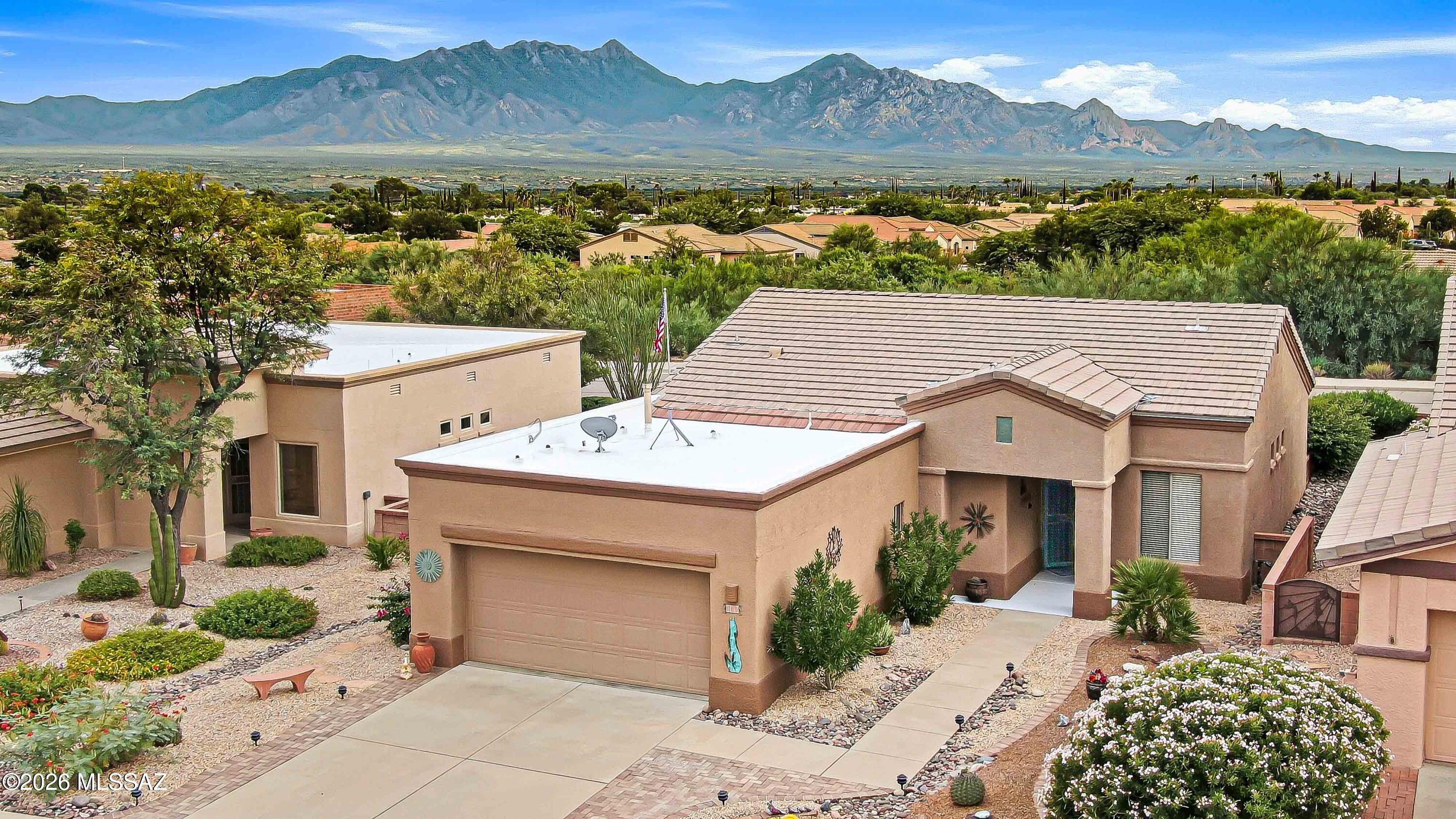 Come see this well-cared-for Las Campanas home with beautiful views of the Santa Rita Mountains. The light and bright great room gives you plenty of space to relax, and the home offers two bedrooms, a den, and a large two-car garage. The kitchen has oak cabinets, quartz countertops, and an electric flat-top range. The guest bathrooms have been updated with a walk-in showers. Some furniture and furnishing are included with the home. The backyard is oversized and has an extended covered patio that is ready for friends, a quiet Arizona evening, or morning coffee with a view that might make you stay for a second cup. This is one you really need to see!