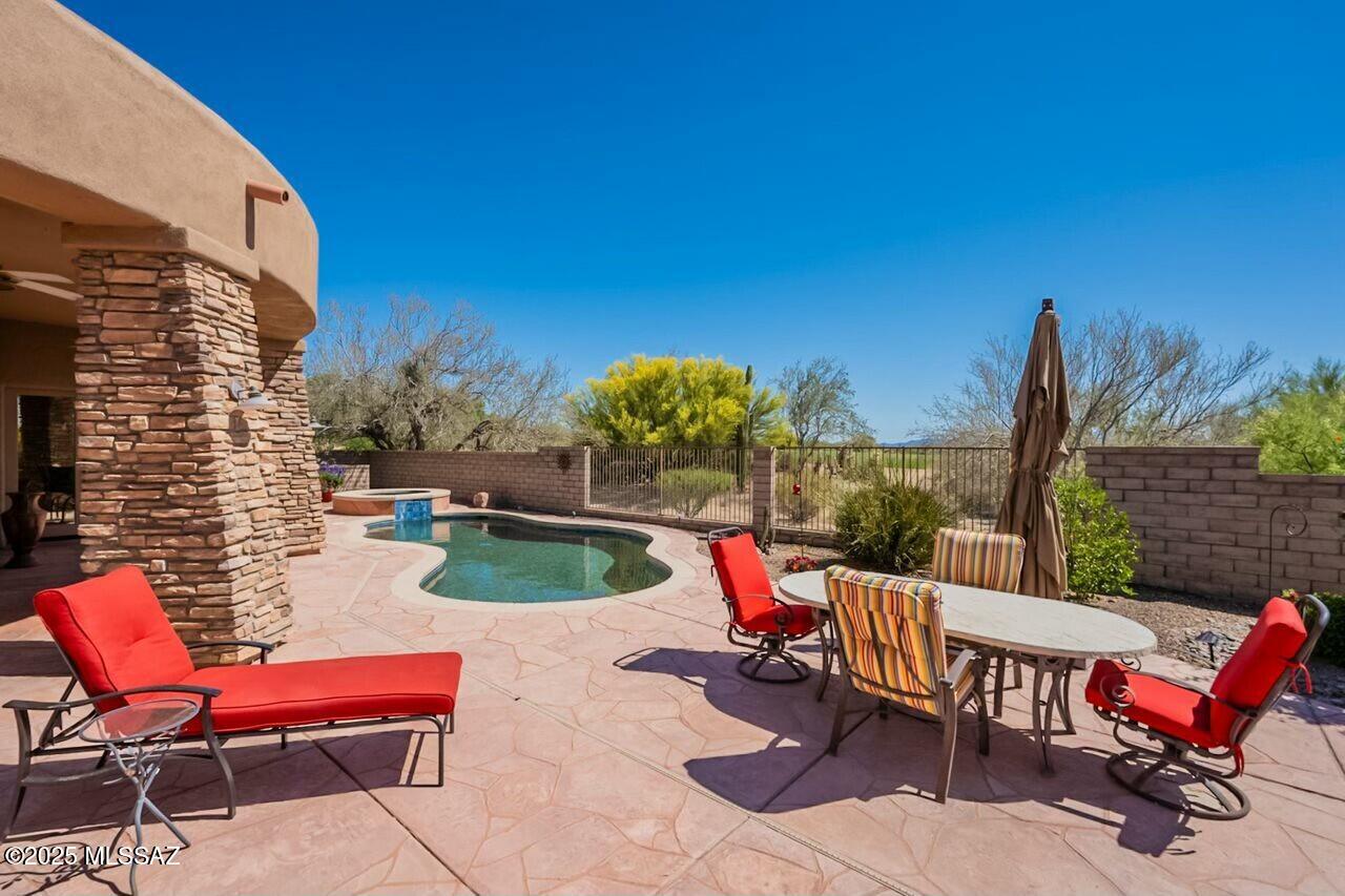 Experience luxury living in this gated community on an expansive ½-acre (+/-) lot overlooking the Gallery South Course, 2nd hole fairway. Enjoy breathtaking desert, golf & sunset views from your backyard oasis. This flexible floor plan is perfect for hosting or even sharing between two couples, w/BDRMS thoughtfully divided between the great room & kitchen areas. Each bedroom features its own private bath for ultimate comfort. Meticulously maintained w/ numerous upgrades: NEW: appliances, AC units/Climate controlled garage), windows & French doors, Drains & front gate, roof. Step outside to your sparkling pool, spa, outdoor kitchen & covered patio—an entertainer's paradise! Easily take your golf cart to the sports club, golf club, or restaurant. Enjoy hiking, biking, the Ritz-Carlton!
