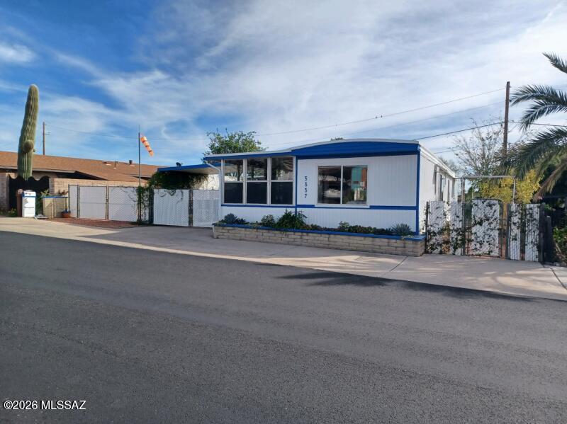 Beautifully updated home featuring fantastic mountain views. This move-in-ready residence offers peace of mind with a newer HVAC system, new Pex plumbing, on demand water heater and a recently recoated roof. The modern kitchen is a gorgeous center place, with a central island, 5-burner gas stove with a vented hood, and a dishwasher. Enjoy the outdoors from the comfort of two Arizona rooms, and take advantage of the functional laundry room and convenient storage sheds. Both bathrooms have been stylishly updated. Fenced Parking and Citrus Trees. As a special bonus, a golf cart included so you can immediately enjoy the HOA's unlimited golf. HOA incl 2 pools, 2 spas, Exercise Facility, Pickle Ball, Tennis, and More. Modern comforts with stunning scenery, rare find in a premier community.