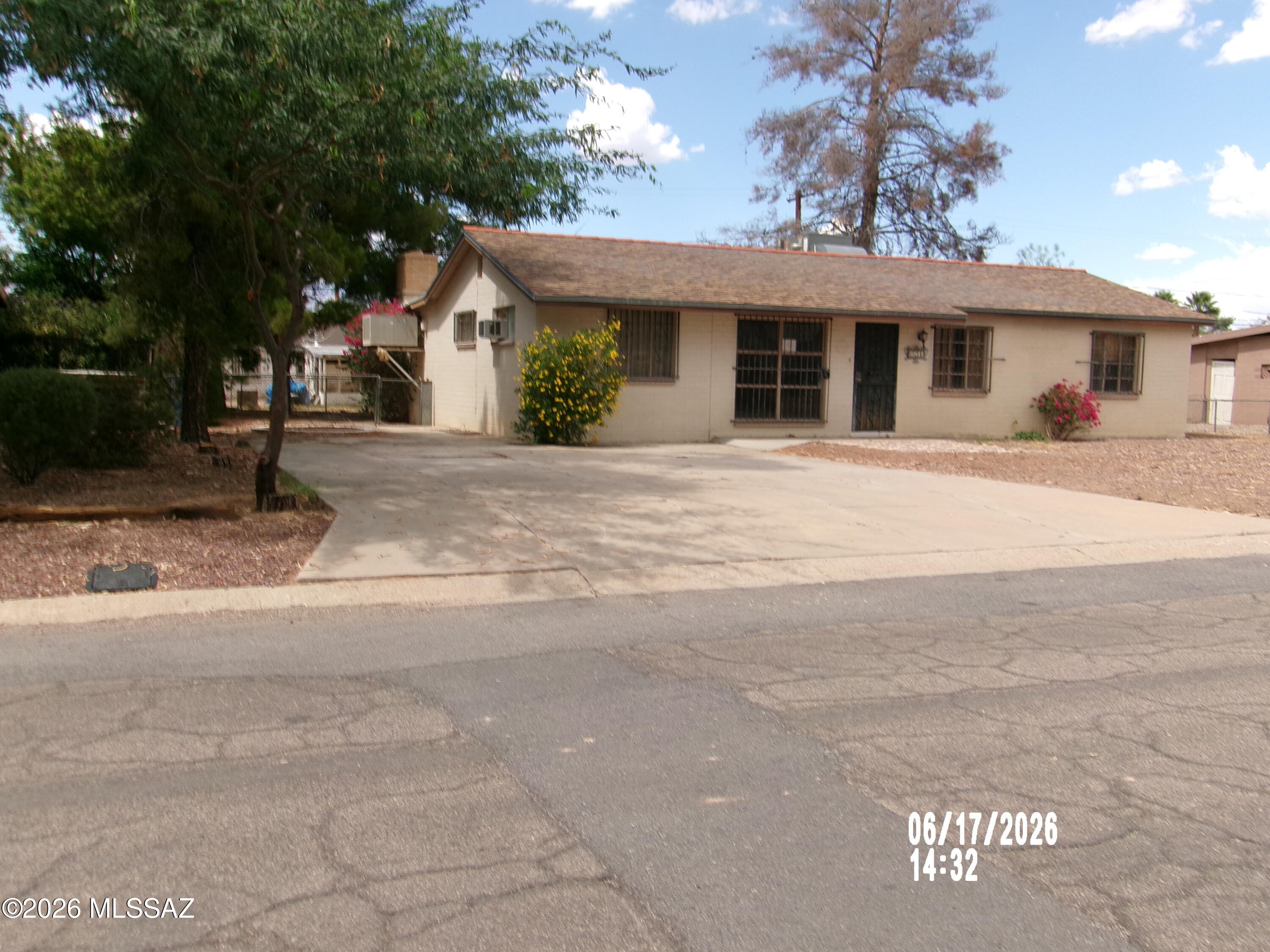 Come see this charming ranch-style home with solid block construction, located in one of Tucson's well-established east-side neighborhoods. This inviting residence offers four bedrooms and an updated bathroom featuring a spacious tiled walk-in shower. The functional kitchen provides ample cabinet storage and generous countertop space, making meal preparation a breeze. Just off the kitchen, you'll find a huge great room anchored by a cozy brick fireplace--perfect for relaxing or entertaining. Step outside to enjoy the large backyard and full-length covered patio, offering comfortable shade throughout the day. This home combines comfort, space, and value in a desirable location.
