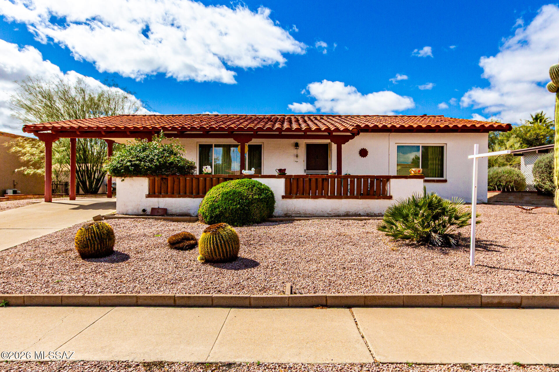 Welcome to this charming home in a quiet adult community featuring 2 bedrooms and 2 bathrooms on a spacious lot. Relax on the covered front patio or enjoy the bright Arizona Room, perfect for hobbies or extra living space. The kitchen offers tile countertops, a pantry, and a window over the sink with a pleasant view. Walk-in storage adds convenience. The large backyard and low-maintenance yards make outdoor living easy. Member of GVR with a location just minutes away. Close to I-19, shopping, and restaurants. MOTIVATED SELLER!