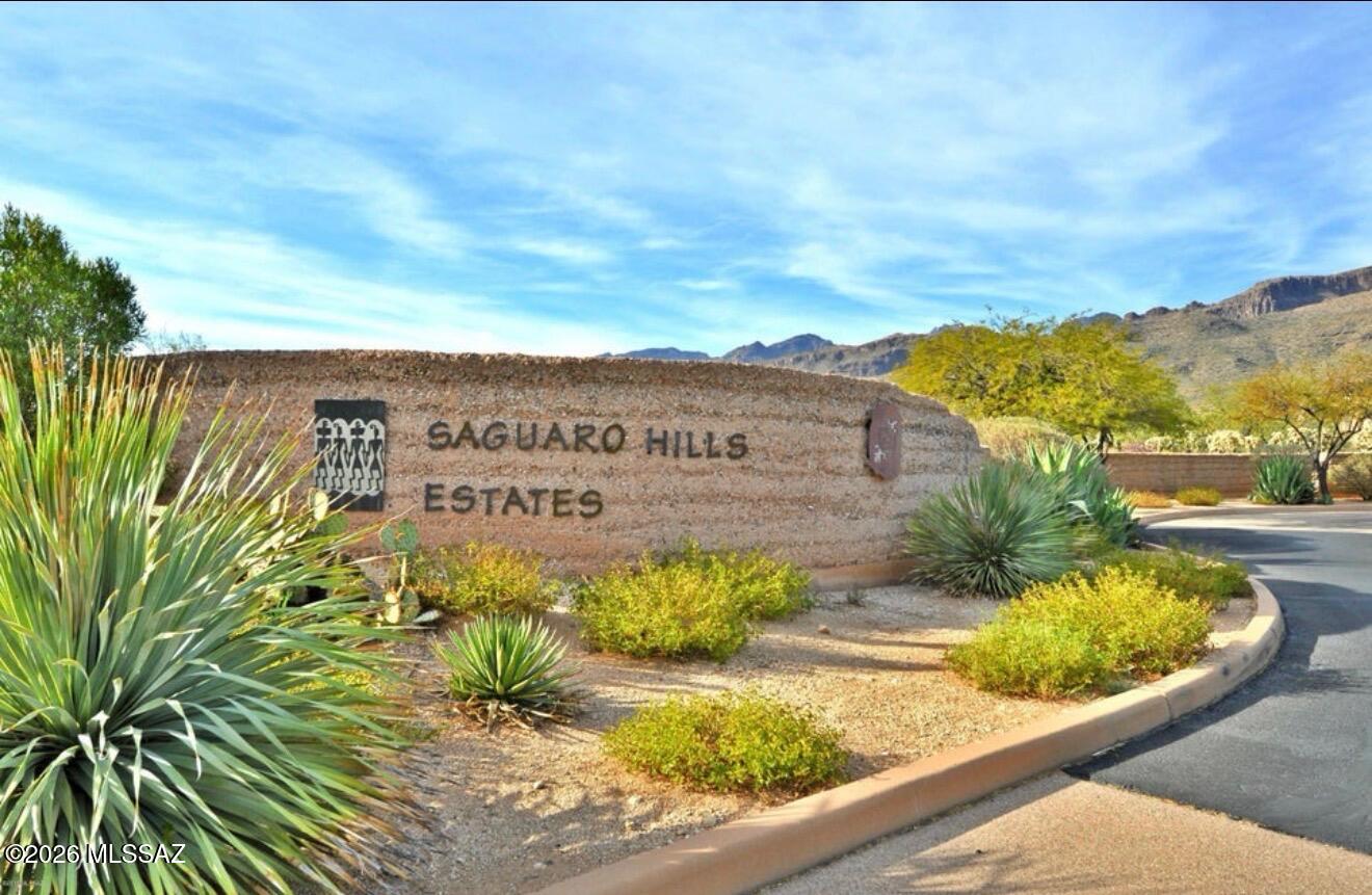 Exceptional elevated homesite in the gated Saguaro Hills community, offering sweeping city and mountain views. One of the community's higher-elevation parcels, this beautiful lot features rolling Sonoran Desert terrain and an abundance of mature saguaros. The natural topography offers flexibility for positioning a custom residence to capture the surrounding views. Underground city water, sewer, electric, natural gas & phone are installed to the lot line per subdivision report. Minimum 3,000 SF residence with architectural design review. Design Guidelines, CCRs, subdivision documents available in MLS documents.