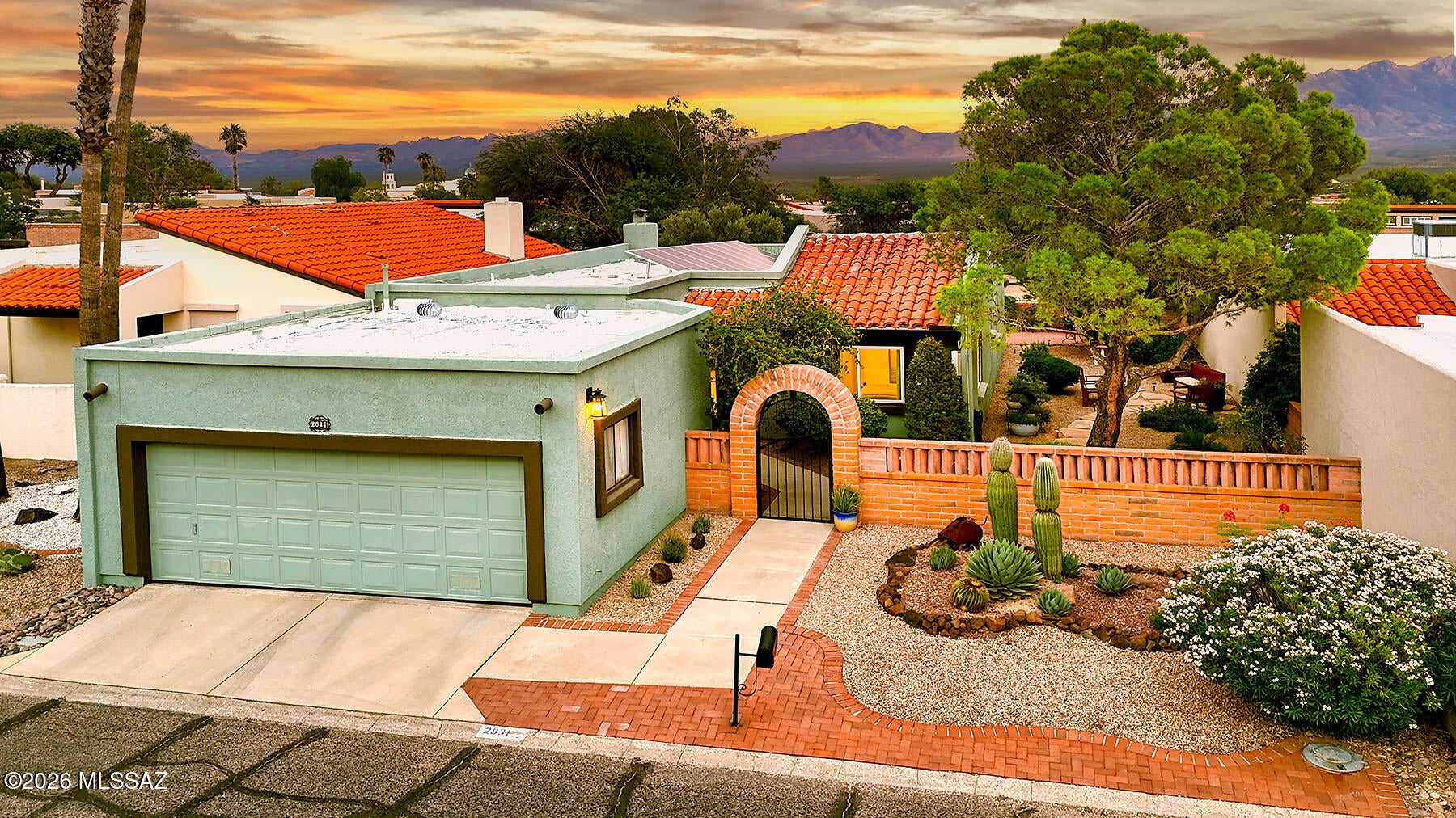 Welcome home to Southern Arizona living at its finest! Pass through a gated courtyard into this beautifully updated 2 bedroom 2 bathroom retreat offering 1434 square feet of thoughtfully designed living space. Step onto the covered back patio and let breathtaking mountain views take your breath away, while birdsong and the gentle trickle of a waterfall create your own private oasis. Gather around the striking beehive gas fireplace in the open great room, where those same stunning views become the everyday backdrop to life. Retreat to the primary suite and wake up to mountain scenery that never gets old. The expansive kitchen is made for both everyday living and entertaining, featuring a center island, built in desk and dedicated dining area, all outfitted with sleek new SS appliances. Live comfortably and efficiently with owned solar keeping utility costs low. New windows with warranty and gorgeous new tile flooring throughout add a fresh, move in ready polish, while removal of the popcorn ceilings brings the whole home into modern style. Outside, a parklike side yard invites you to relax or entertain in total privacy, with no rear neighbors on this peaceful street. Ideally located just minutes from the Desert Hills Rec Center, this is the Green Valley lifestyle, and those mountain views, you have been dreaming of. Come see it for yourself!