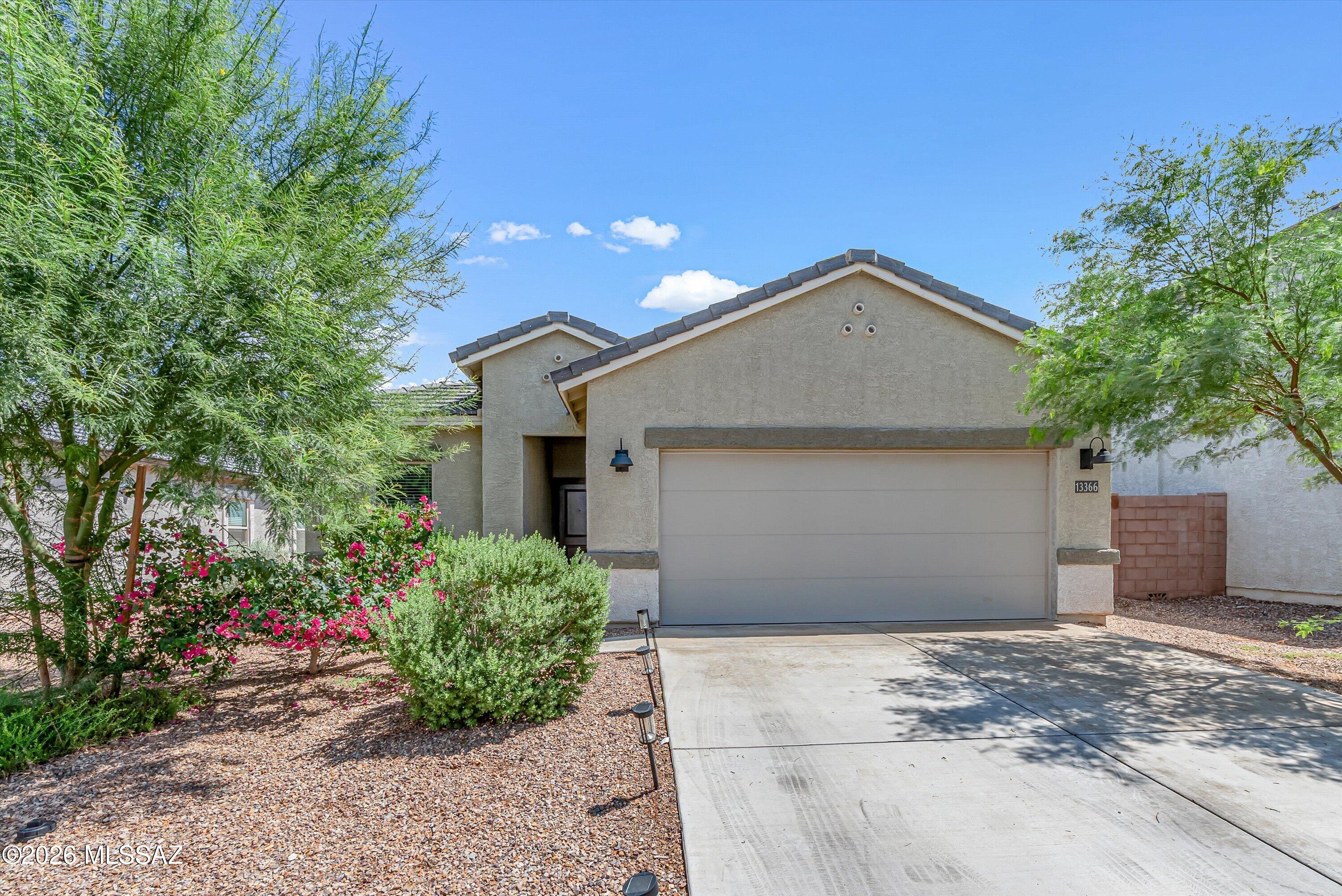 4.99% ASSUMABLE LOAN! Get the popular Baxter floorplan without the added cost and work of finishing the backyard. This 3-year-old home has no rear neighbor, a large backyard with artificial turf and pavers, and views of Mt. Lemmon, the Catalina, Tortolita, and Tucson Mountains. Inside, the split floorplan features a spacious kitchen with granite countertops, stainless steel appliances, a gas range, an island with seating, and a large pantry. The bathrooms include matching cabinetry and countertops. Tankless water heater included.