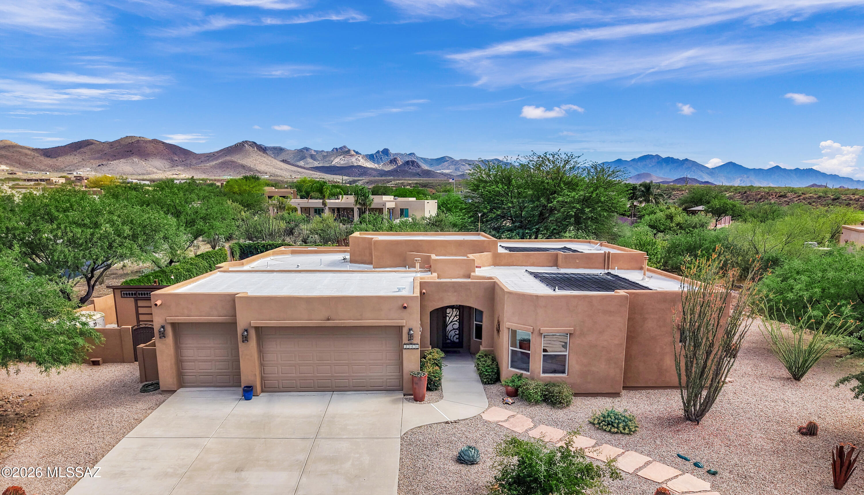 This stunning Sombra home features 4 bedrooms, 3 baths, 2603 SQFT on .74 acre lot in the desirable Vail area within the award-winning Vail school District. Built with durable 2x6 construction, this move-in ready home offers a custom iron front door, and an open light-filled floor plan. Interior highlights include solid wood cherry Merillat cabinetry, Bali insulated window blinds, ceiling fans throughout, and new porcelain tile in the primary bedroom, closet, and office. Bedrooms 2 and 3 offer newer carpet. Bedroom 2 has its own private bathroom. The home is equipped with a dual HVAC systems and a fire sprinkler suppression system for added efficiency and peace of mind. All three bathrooms have been upgraded with new granite countertops, updated sinks and faucets, and a granite surround in the primary bath, along with a heated towel rack and additional matching fixtures throughout. New GE washer and dryer. The expansive backyard is designed for both relaxation and entertaining, featuring professional xeriscaping, terraced landscaping with mature trees, real grass, and a private pool with solar heating. Enjoy a ramada, designated lighted BBQ area, app-controlled fountain, and professional outdoor lighting. The space is enhanced with wired Bose outdoor speakers with volume controls and four rechargeable, color-changing pool lights. Additional features include a 3-car garage with its own AC unit, three storage sheds, a wall/roof-mounted weather station, and a 50 amp RV outlet.