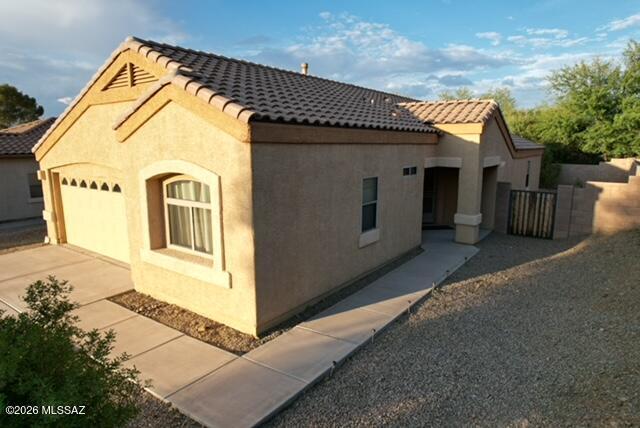 Immaculate and move-in ready Lennar home featuring a desirable 3-bedroom, 2-bath split floor plan with an open great room design. The spacious kitchen offers corian countertops, a center island, GE gas range, GE Profile microwave and dishwasher, and a walk-in pantry. The private primary suite includes dual his/her closets and an upgraded tile walk-in shower. Laminate wood flooring enhances the great room, while ceiling fans throughout provide year-round comfort. Perfectly situated on a premium lot backing to a greenbelt for added privacy. Recent updates include a new A/C, water heater, and garage door. Additional features include garage organizers and an extended covered paver patio, perfect for outdoor living. Located in the award-winning Vail School District.