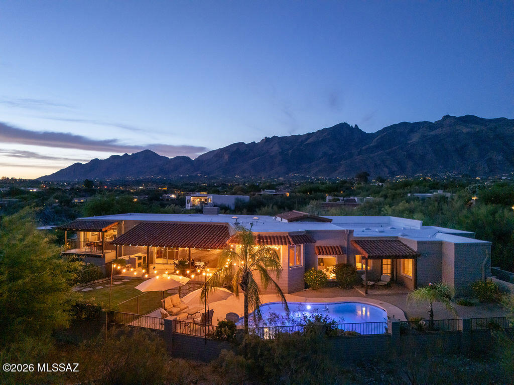 Gorgeous mountain and city views plus an underground, walk-in, refrigerated wine cellar makes this outstanding home one of a kind. Updated in 2007 with new kitchen and appliances, bathrooms with Jacuzzi tubs, travertine and solid wood floors and more. This 4200 sqft home boasts an amazing open space area with a beautiful gourmet kitchen, family room and a large entertainment/game room. It has 4 bedrooms, 3 (2+1) bathrooms plus built-in provisions for an additional bathroom. Large backyard with a pool. Large concrete driveway. Easy access to Catalina Foothills High School and the U of A. Located in a very desirable subdivision close to shops, restaurants, schools, hiking trails and more. See list of UPDATES and FEATURES under documents. ONE OF THE OWNERS IS A LICENSED REAL ESTATE AGENT IN