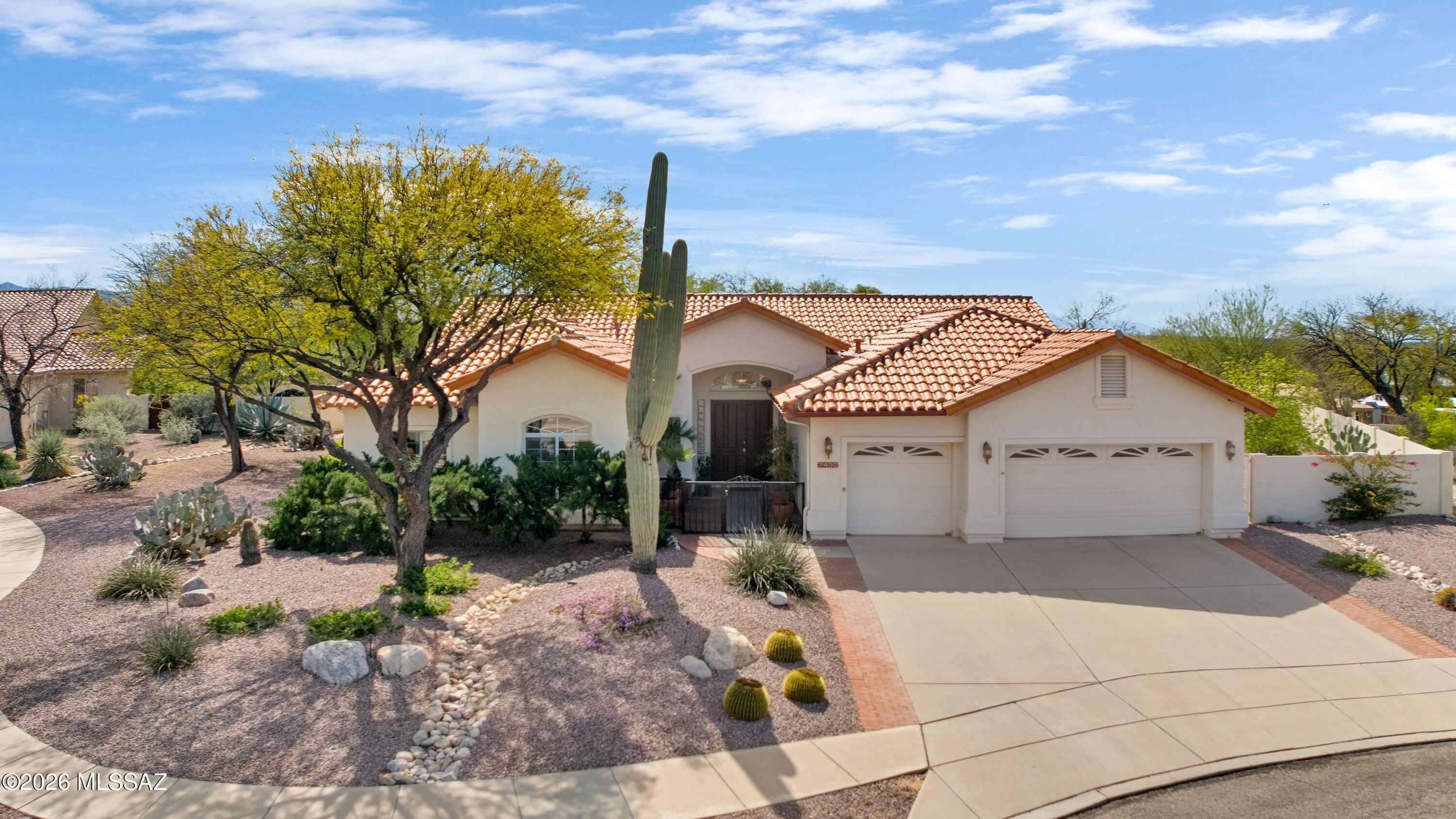 Enjoy Catalina Foothills living on a beautifully landscaped .48-acre cul-de-sac lot near Sabino Canyon Recreation Area. Gorgeous front landscaping and a welcoming front courtyard create an inviting entrance to this spacious 3,121 sq ft home with desirable north/south orientation. 
At the heart of the home is a bright white kitchen with a large center island, breakfast bar, and abundant cabinetry, opening to the family room with a cozy gas fireplace and patio access--perfect for everyday living and entertaining. The welcoming living room features vaulted ceilings and large picture windows that fill the space with natural light and frame the surrounding desert landscape. 
The thoughtfully designed split bedroom floorplan includes an enormous primary suite with direct patio access, creating a peaceful retreat.

Step outside to a beautifully landscaped backyard with fruit trees, offering space for outdoor living and room to add a pool. Additional features include a 3-car garage with extensive built-in storage and a central vacuum system.

Ideally located near Sabino Canyon Recreation Area, Udall Park, hiking trails, shopping, and dining, this home offers the perfect combination of space, comfort, and Catalina Foothills lifestyle.
