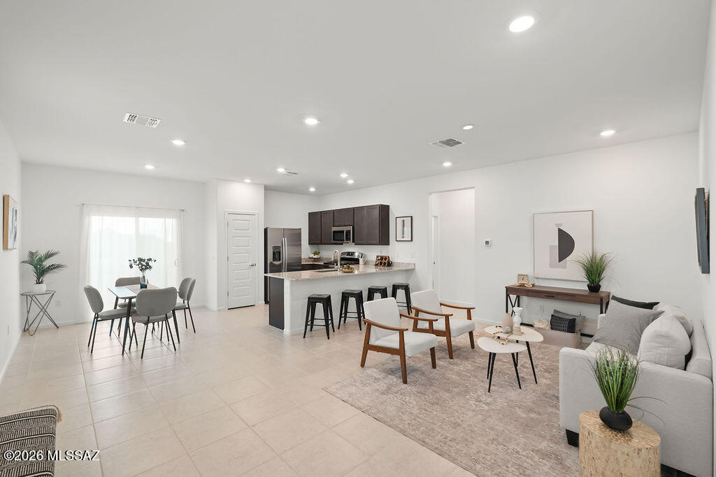 The seller will consider offers between $297,000 and $307,000.

Welcome to 8713 E Creamy Cliffrose Trail in the highly sought-after Vail School District! Why wait months for new construction when you can move into a nearly new home that has been gently lived in for only a combined three months?

Nestled in a growing Vail community, this beautifully maintained home offers breathtaking Rincon Mountain views with no homes directly behind, creating a private backyard setting where the views remain unobstructed. Whether you're enjoying your morning coffee at sunrise or unwinding after a long day, the mountain backdrop provides the perfect Arizona lifestyle.

Inside, you'll find a warm and inviting great room designed for both entertaining guests and enjoying quiet evenings at home. High ceilings and 8-foot doors enhance the spacious feel throughout the home, while the open-concept layout flows effortlessly, making the living space feel comfortable, functional, and connected. Thoughtfully built with a passive solar design, the home is positioned to help keep interiors cooler and more energy efficient during Arizona's warmer months.

Residents enjoy access to the outstanding Sycamore Canyon HOA amenities, including a community pool and spa, sports fields, and scenic walking and jogging paths. The home is also conveniently located near shopping, dining, and everyday conveniences found in both Sahuarita and Houghton Crossing, offering the perfect balance of peaceful living and accessibility.

With modern finishes, minimal wear, stunning mountain views, energy-conscious design, and a location that continues to grow in popularity, this home offers an exceptional opportunity to own a nearly new property without the wait, uncertainty, or added expense of building from scratch.

Schedule your private showing today and discover why homes with views like these don't stay available for long.