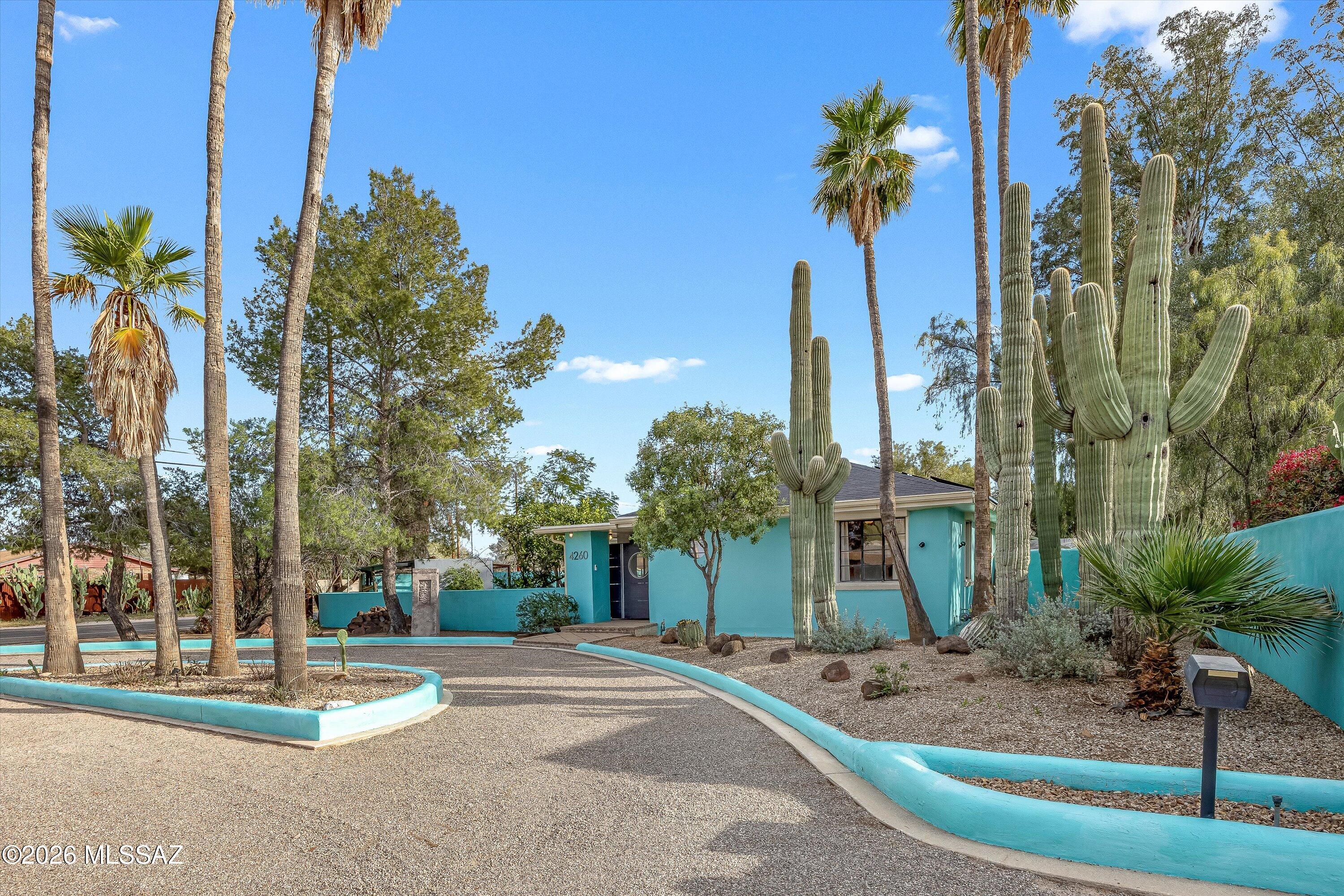 Welcome to the ''Blue House!'' Located in the historic San Clemente subdivision. This unique home exudes character in every room including real wood floors, mahogany cabinets, a wood burning fireplace, built-in office space, a laundry room with loads of storage & a finished basement! Detached hobby room/casita is heated/cooled. Outside you'll find a lovely courtyard, waterfall, sparkling pool, treehouse, fruit trees & water cistern. Sustainable living with solar panels too! Plumbing upgraded to copper & PEX! Roof just 10 years old.   Just blocks from San Clemente's neighborhood park, 4 miles from the UofA & Banner UMC, 2 miles from Reid Park & so much more!