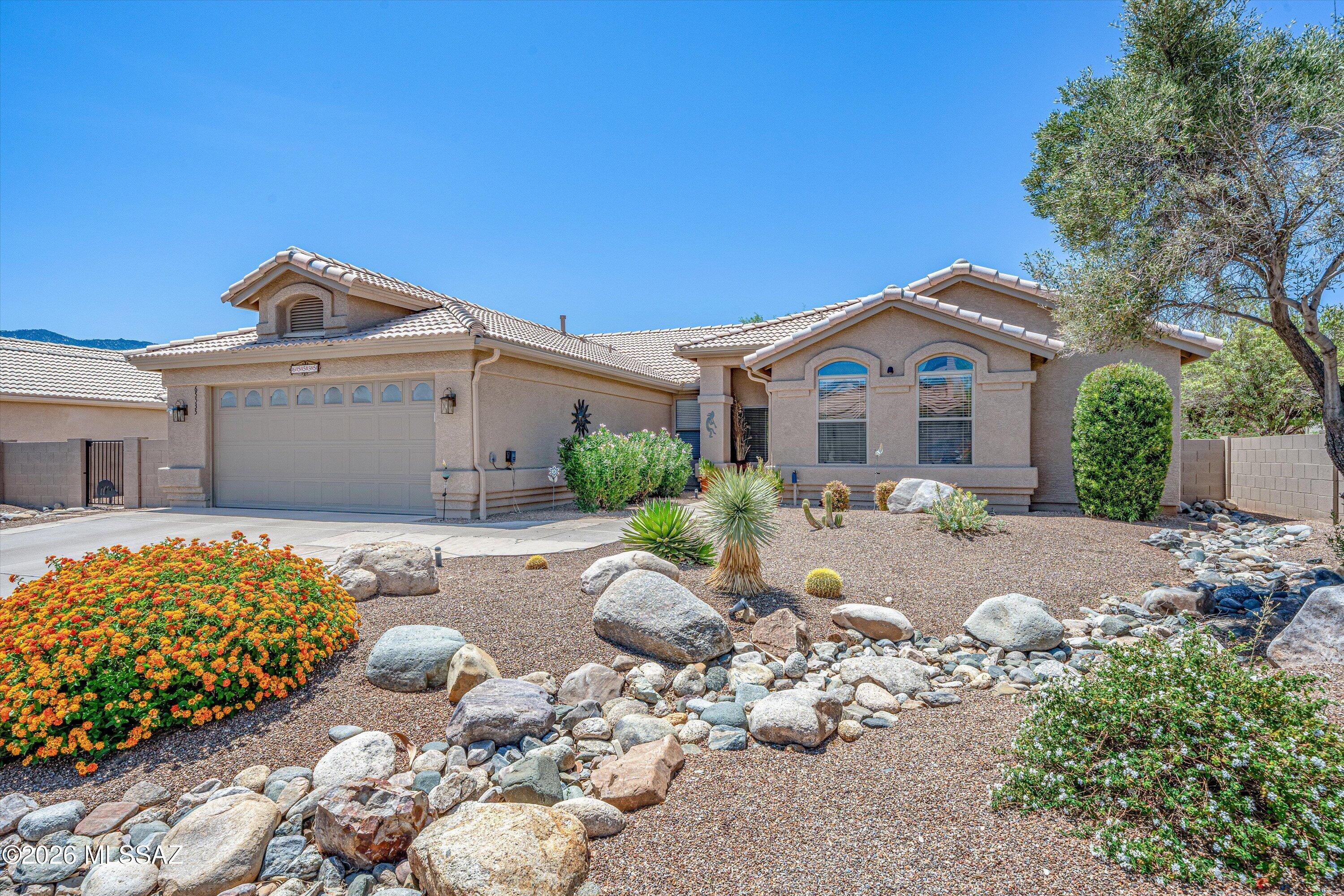 Beautifully positioned on the golf course with breathtaking mountain views, this updated Topaz model is truly move-in ready. The living and family rooms have been thoughtfully opened to create a spacious, open-concept great room, perfect for entertaining. A custom built-in entertainment wall with a cozy gas fireplace anchors the space, while a large patio slider frames the stunning outdoor views.

The remodeled kitchen features granite countertops, stainless steel appliances, alder cabinetry, pantry pull-out shelves, and a sunny breakfast nook. The spacious owner's suite offers direct patio access, a walk-in closet, and a beautifully updated ensuite with a walk-in glass-enclosed shower. Two guest bedrooms provide flexibility, including an extended bedroom ideal as a den or home office, with an updated guest bath nearby. Additional upgrades include exterior paint (2022), new irrigation system (2023), roof underlayment replaced in 2025, and HVAC and water heater (2018). The extended two-car garage offers abundant storage with built-in cabinets, a utility sink, and workspace. Relax on the covered patio with four electric rolling screens or enjoy the extended flagstone patio beneath the pergola while taking in the Catalina Golf Course and spectacular mountain views. Mature landscaping and a fruit tree complete this exceptional SaddleBrooke home.