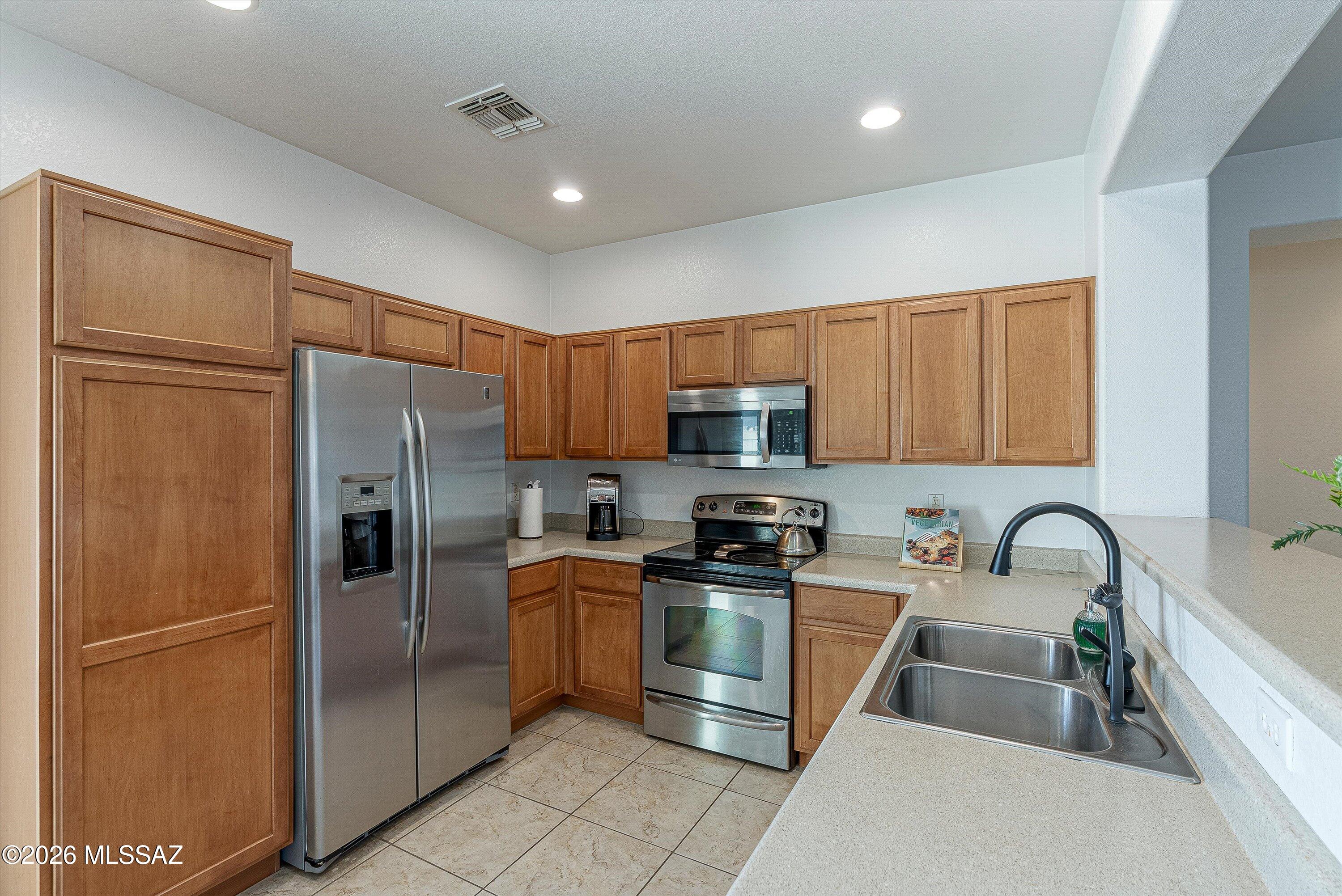 Discover the perfect blend of comfort and convenience in this immaculate single-story home located in Red Rock Village. This move-in ready 3-bedroom, 2-bath residence offers a bright, functional layout with ceramic tile throughout for effortless living. Enjoy added privacy with no rear neighbors and direct access to a peaceful walking trail--perfect for morning strolls and sunset views. Located in a growing community with resort-style amenities including pools, parks, and sports courts. Easy access to I-10 makes commuting to Tucson, Marana, or Casa Grande seamless. A true blend of style, lifestyle, and value.