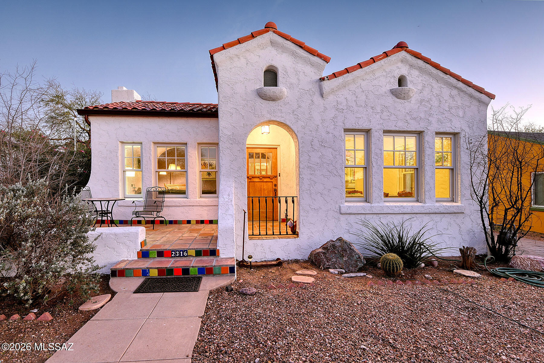 Spanish Mission bungalow, charmingly updated while preserving the home's original integrity. Built in 1929, this residence offers three bedrooms and two full bathrooms. The living and dining rooms feature beautifully coved rooms, an uncommon and distinctive architectural detail. Rich hardwood floors, classic niches, and original 1929 tile framing the fireplace add timeless character throughout. A vintage kitchen, with a Mexican tile backsplash, checkered linoleum floors, vibrant blue and white countertops, and the original O'Keefe & Merritt stove, along with a butler's pantry and laundry area. A basement offers flexible additional living space along with a separate storage room. Thoughtful updates include newer dual-pane, double-hung windows and French doors. Enjoy the welcoming front porch, perfect for morning coffee or evening conversations with neighbors, and a covered back patio ideal for entertaining in your walled & private backyard. Owned solar system provides excellent energy efficiency and significantly reduced electricity costs. Recent improvements include a freshly coated roof and tile roof replacement (March 2026). The property also features a one-car garage in the rear and additional off-street parking in the front.