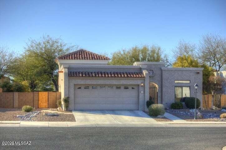 Former Model Home with all steel construction in prestigious Pedrigal.  15ft great rm ceiling with halo lighting, scored dyed concrete floors, Heat&Glow Behive Fireplace.  Gated Atrium Courtyard Entry w/fountain, extended flagstone covered patio &walkway. 2 Car Garage w/blt in cabinets, water softener. Kitchen w/granite counters/stone backsplash. Mst. Bath w/dual sinks.huge walkin shower & travertine tile, granite counters, dual sinks and walk in closet.  Upgraded lighting throughout, gorgeous Spanish subdivision with natural gas lantern in font yard.  Close to Tucson OMNI Resort & Spa, YMCA, PCC, shopping & dining.   Presently rented on Mo to Mo at $2000.  Occupant will stay for investor, or leave if owner occupant.  Showing available at certain time in showing instructions