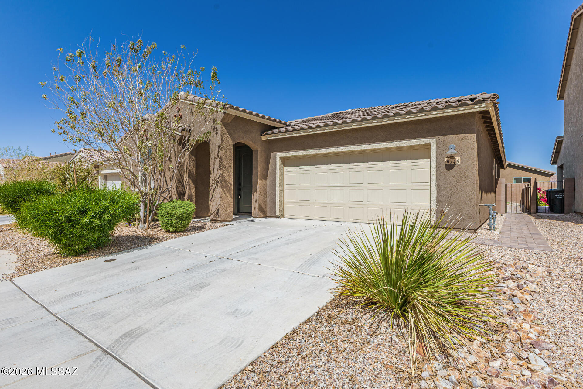 This modern gem in Saguaro Trails is better than new as the upgrades and landscaping have already been perfected. This beauty showcases multiple bedroom en-suites, an open-concept kitchen w/shaker cabinets & crown molding, a classy tile backsplash, sleek stone countertops, SS appliances, and a perfect centerpiece island. The primary retreat includes a walk-in closet, and a spacious bathroom with a dual-sink vanity and a tiled walk-in shower. Step out back to enjoy the covered patio and the low maintenance backyard of pavers and native desert cacti. Last but not least, enjoy the 7 acre amenity center which features a resort style pool, splashpad, ramadas, dog park, playground, sports court, walking trails, and more! This home has been immaculately maintained and pride of ownership is clear.