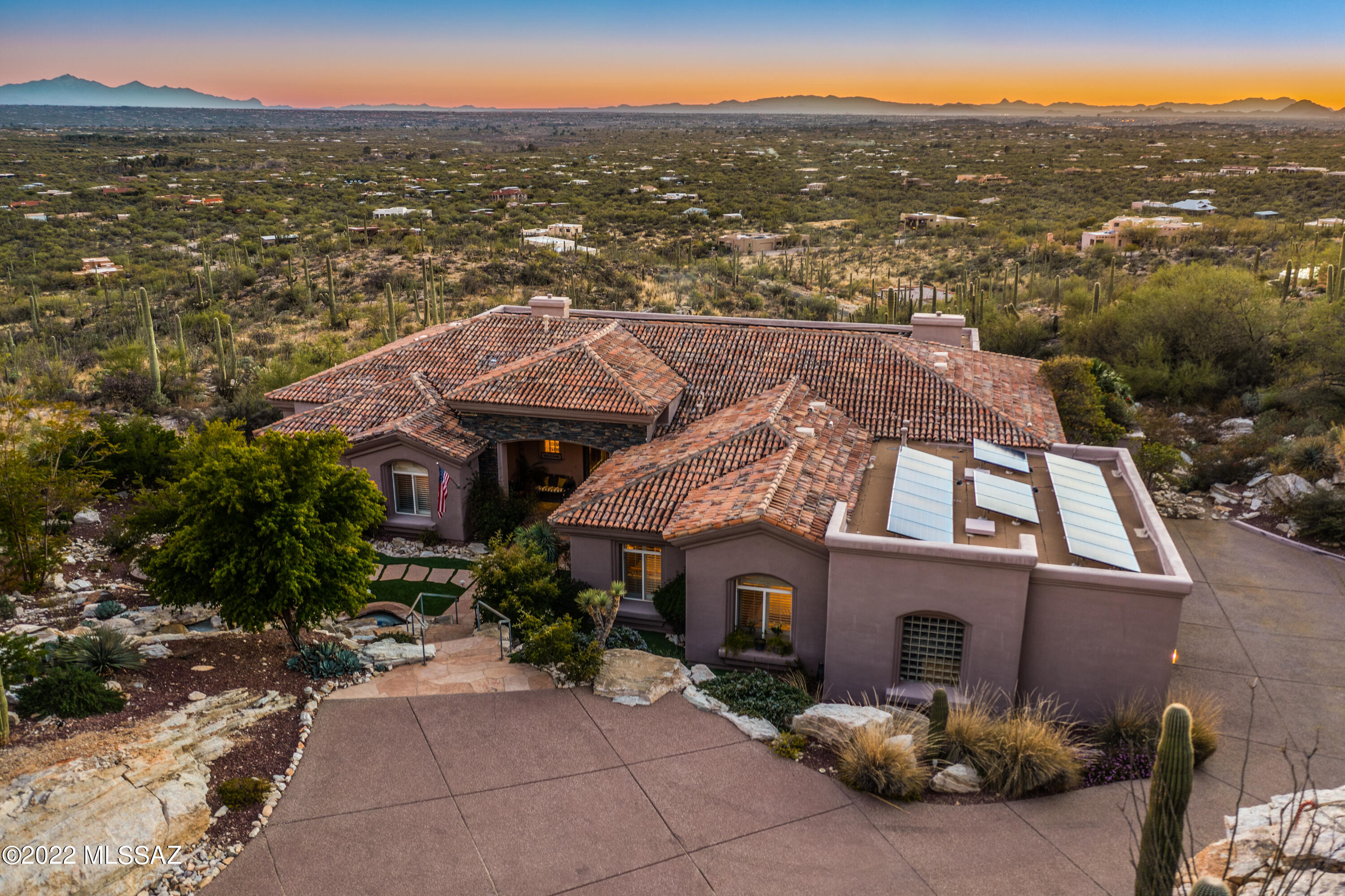 Home is range priced $2,000,000 - $2,050.000. Welcome to a Mira Vista Estates Gem!  This mountainside home offers elevated living with stunning city and sunset views. A cascading waterfall welcomes you at the entrance, complemented by striking metal doors and a front sitting area with a fire pit. Inside, the home features thoughtful upgrades, including a high-end sound system, custom lighting, rolling shades, and shutters throughout. The backyard is designed for relaxation and entertaining with an extended covered patio, outdoor fireplace, seating area, spa, and private turf area. Expansive windows frame the surrounding scenery, allowing the mountain, sunset, and city light views to be enjoyed from both inside and outside the home.
