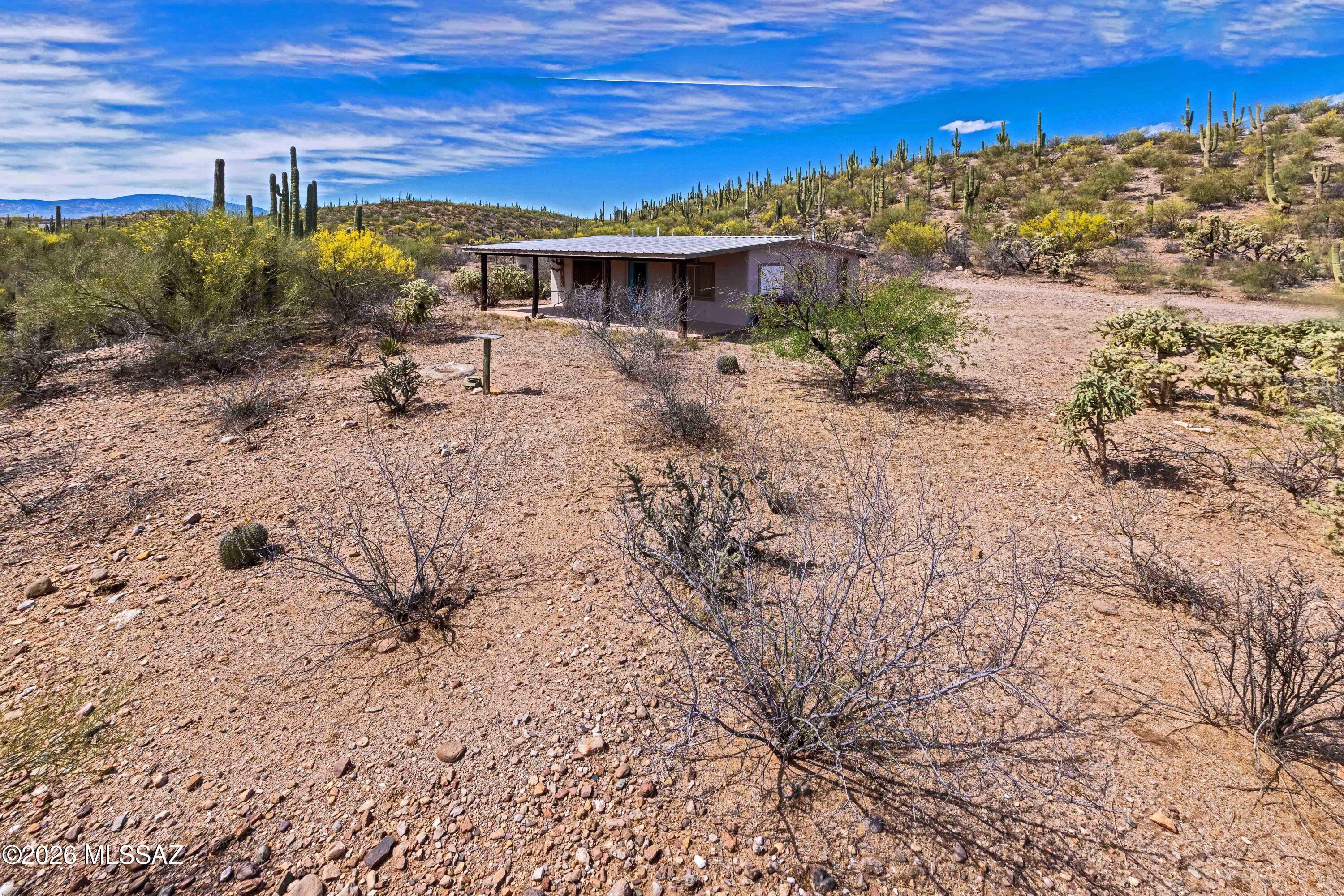 A rare opportunity to own a private retreat with stunning desert and river views. 2 parcels totaling 8.26 ac a private well, breathtaking views of the San Pedro River and the Galiuro Mountains. Home is perfectly situated for privacy and cannot be seen from the road, providing a secluded setting. Almost everything stays except owners personal stuff and a few items. Two sheds. The second parcel includes an Airstream trailer with renovation potential, ideal for guests. Experience off-grid living at its best. 
Home is powered by 1-100 watt solar panel that charges a marine battery for lighting, propane fuels the refrigerator, heater, stove and water heater. A generator operates the well, with water pumped into a 1100-gallon storage tank that gravity-feeds into the home. Adjacent to state land