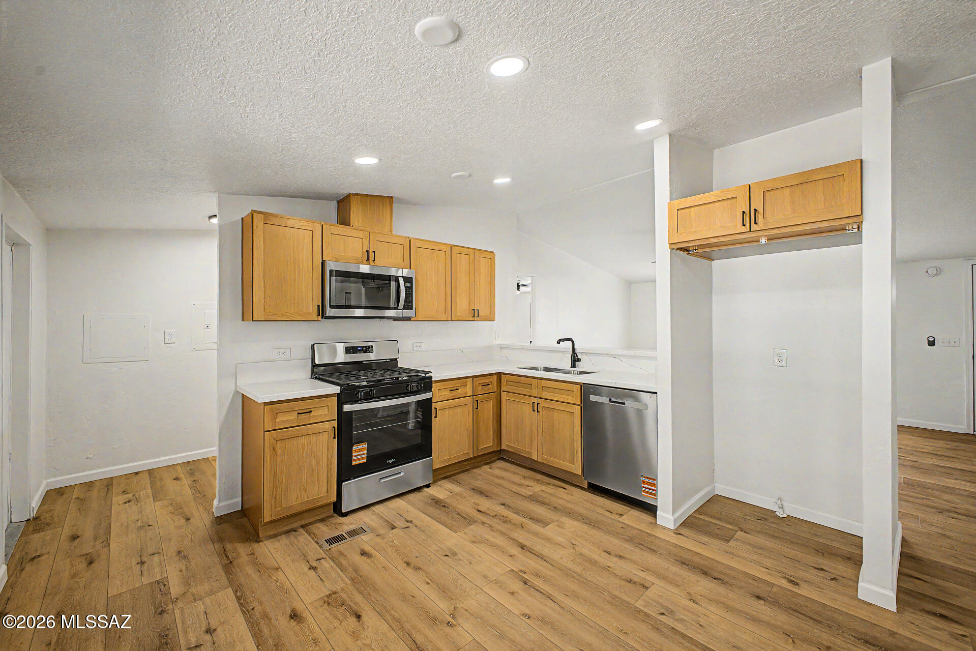 Updated 3-bedroom, 2-bath manufactured home in Northwest Tucson's desirable Casas Adobes community. Features include luxury plank flooring, new carpet in bedrooms, modern electrical and plumbing fixtures, quartz kitchen countertops, neutral cabinetry, stainless steel appliances, and updated bathrooms with new cabinetry and shower enclosures. Additional improvements include a new shingle roof, fresh interior and exterior paint, refreshed landscaping with decorative rock, and an extended covered patio. Enjoy community amenities including a pool and clubhouse, with convenient access to schools, shopping, medical facilities, and freeway connections. Move-in ready and a must see!
