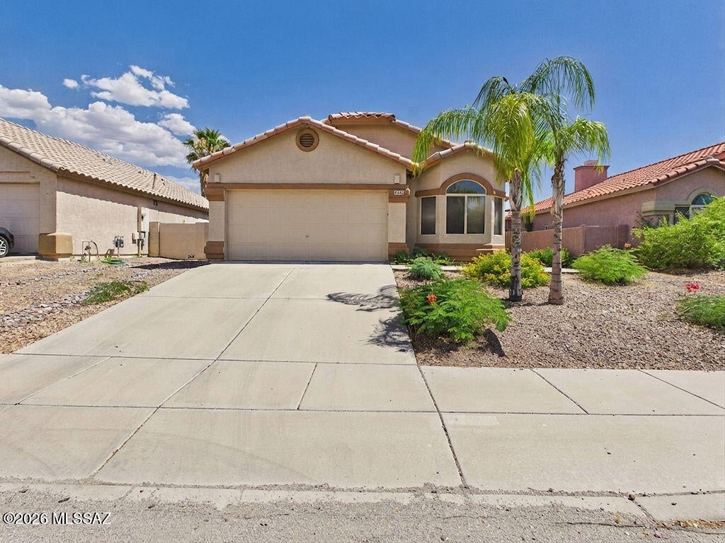 This bright and welcoming single-story home offers a spacious open layout with 3 bedrooms and 2 bathrooms, designed for comfortable everyday living. Soaring ceilings and large windows fill the main living area with natural light, while the cozy fireplace with tile surround adds warmth and charm.
The kitchen provides generous cabinetry, tile countertops, a center island, pantry storage, and a sunny dining nook with bay-style windows — the perfect spot to start your day.
The primary suite offers great space, peaceful backyard views, and an en-suite bath with dual sinks and a tub/shower combo. You'll also appreciate the indoor laundry room and a two-car garage with finished flooring. Step outside to a covered patio and private backyard with mature trees and a shade structure  ideal for relaxing or entertaining year-round.