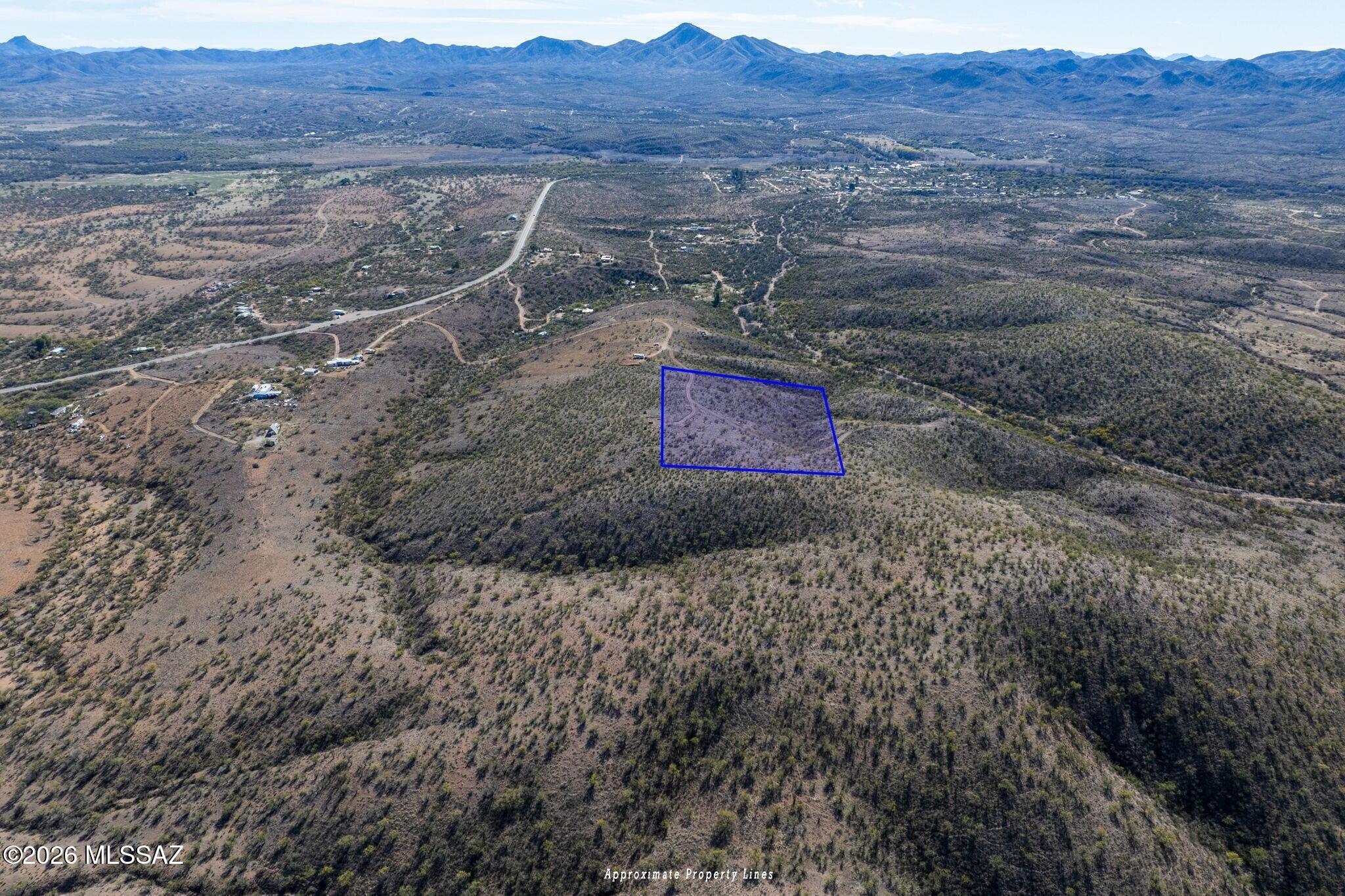 Tucked into the high desert in Arivaca, this 10-acre parcel, known as Amigo Wash, offers space, privacy and to-the-horizon views. Bordered on two sides by state land, the setting is expansive and protected. Nestled approx 800 feet off a paved road, it sits within a gated area served by a shared well, with electric about 500 yards away. True 360° mountain vistas include Baboquivari Peak to the northwest, the Las Guijas Mountains due west, the San Luis Mountains to the south and the Cerro Colorado range to the northeast. Want to go bigger? An adjacent 10-acre parcel can be yours, for a combined 20-acre private retreat or hobby ranch with plenty of breathing room. Minutes away from the town offers community, local character and a slower, more intentional pace of life.