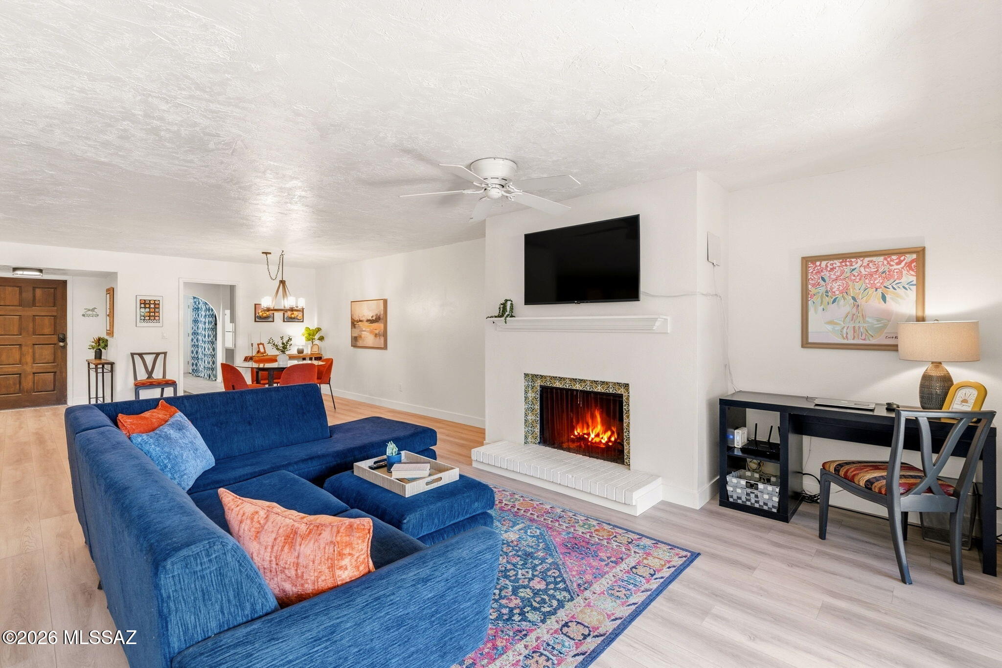Bright, Light and Inviting 1st story Condo.  2 Bedrooms, 2 Bathrooms and 2 private patio outdoor living spaces. Green and luscious courtyard access to a private front patio.  Large open living/dining areas with sleek new luxury vinyl plank floors. Wood burning fireplace with original tile work, a nod to mid-century vibes. Kitchen offers ample counter top and cabinet space along with a kitchen nook area for dining and laundry closet. Split bedroom plan affords privacy for all; each bedroom has sliding glass door entry to private patio spaces.  Primary bedroom is generous in size with a walk-in closet, beautifully updated bathroom with custom walk in shower and double vanity. Located near the community pool for ease of access. 1 dedicated covered parking space and separate storage closet. HOA covers exterior care, water, sewer, trash, community pool/spa, private road maintenance and roof maintenance. Centrally located and convenient to shopping, dining, parks and public transportation. This home has so much character - come see this move-in ready charmer in person today!