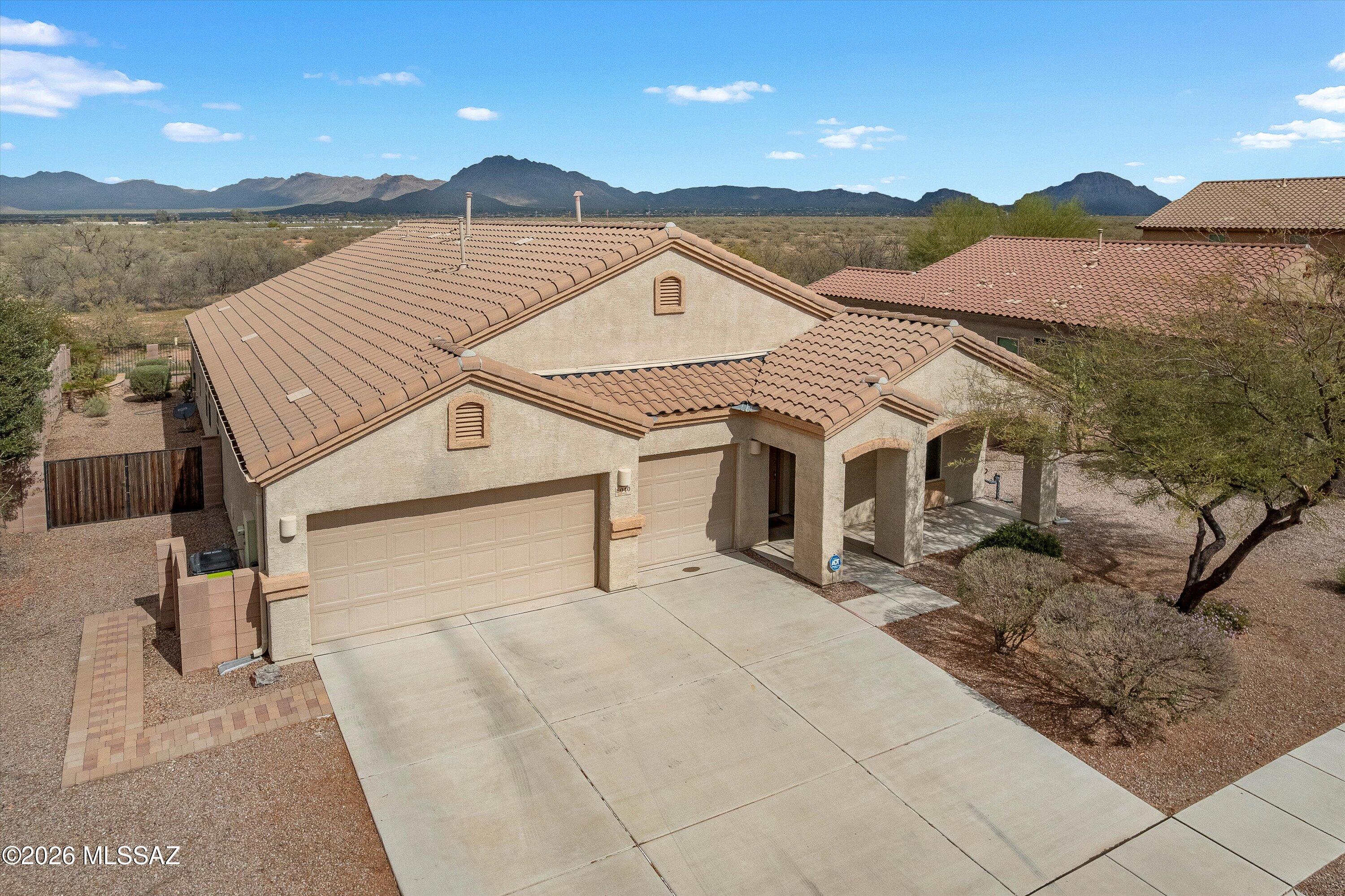 Extensively upgraded 3 bedroom, 2 bathroom home offering 2,543 sq ft with vaulted ceilings throughout and a 3 car garage. Built in 2015, this home features a highly upgraded kitchen with 42'' cabinets with lighting, granite countertops, tile backsplash, gas cooktop, double wall oven, stainless steel appliances, large walk in pantry, oversized island, and built in desk. The family room showcases a custom built in entertainment center with dry bar, wine rack, roll out shelving, accent lighting, and surround sound. Engineered wood flooring highlights the dining room and library. Private north facing backyard with no rear neighbor, desert and mountain views, view fencing, covered patio, pavers, putting green, and a full outdoor kitchen with natural gas. The attention to detail continues throughout the home. The library is a true standout, featuring custom built in bookshelves capable of holding over 1,000 books, engineered wood flooring, and a warm, inviting feel while overlooking the front yard. One secondary bedroom was thoughtfully expanded by removing a wall, creating a massive flex space with engineered wood flooring, ceiling fan, built in Murphy bed, custom cabinets, and built in desks, ideal for guests, hobbies, or a home office.

The hall bathroom offers dual sinks, quartz countertops, tile flooring, and a private water closet separating the toilet and tub/shower combination. The primary bedroom includes upgraded carpet and ceiling fan, while the primary bathroom features dual sinks, quartz counters, tile flooring, framed mirrors, upgraded lighting, an upgraded shower, and a walk in closet.

The spacious laundry room includes both upper and lower cabinetry. The backyard is designed for Tucson living with a north facing orientation, desert and mountain views, artificial turf putting green, mature landscaping with palms, flowers, and cactus, plus an impressive outdoor kitchen with natural gas BBQ, pizza oven, refrigerator, seating, and entertainment space. This home is loaded with upgrades and designed for both comfort and entertaining.