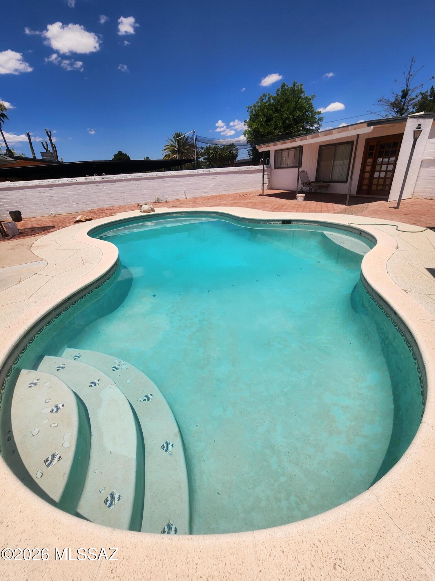 Charming brick home with pool and guest quarters in Douglas! This well-maintained single-story residence offers main house 1,373 sq. ft. of living space with 4 bedrooms and 2.5 bathrooms. Built in 1963 with solid brick construction, the home combines timeless character with everyday functionality. Situated on a spacious corner lot, the property features a refreshing conventional swimming pool, covered patio, and low-maintenance landscaping, creating the perfect setting for outdoor entertaining and relaxation. The central air conditioning provides year-round comfort, while the practical floor plan offers flexibility for families, guests, or a home office. A standout feature is the pool house with guest quarters, providing additional space for visitors, multigenerational living, or potential rental opportunities. Conveniently located in Douglas, this unique property offers a rare combination of indoor comfort, outdoor enjoyment, and versatile living space. Don't miss the opportunity to own this exceptional property with a pool, guest quarters, and plenty of room to enjoy Arizona living.