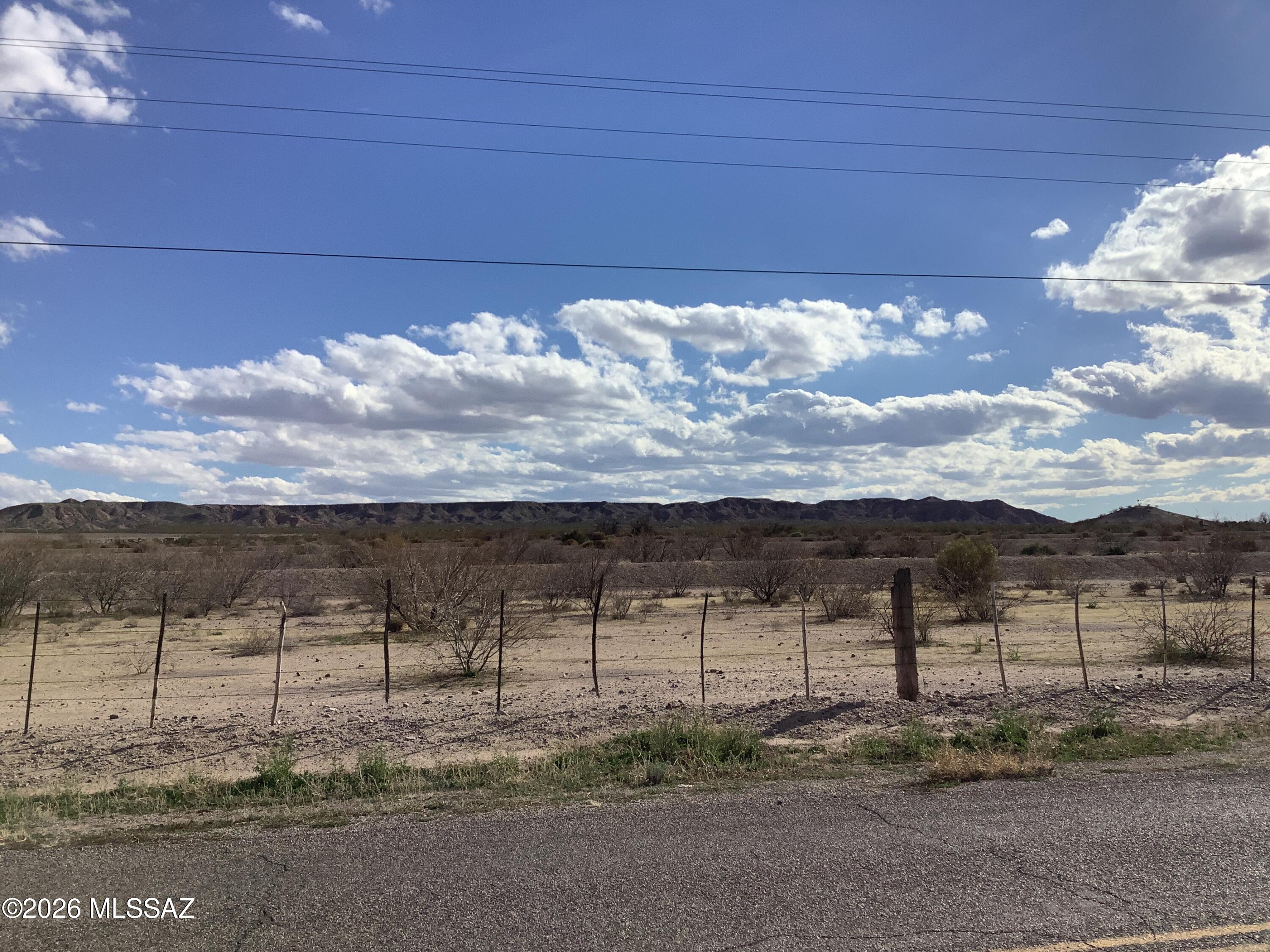 Build your dream home on this beautiful tri-level land completely fenced and surrounded by farmland but on paved road. The property has electric and has a well share.  Fantastic views of the mountains and not far from town.