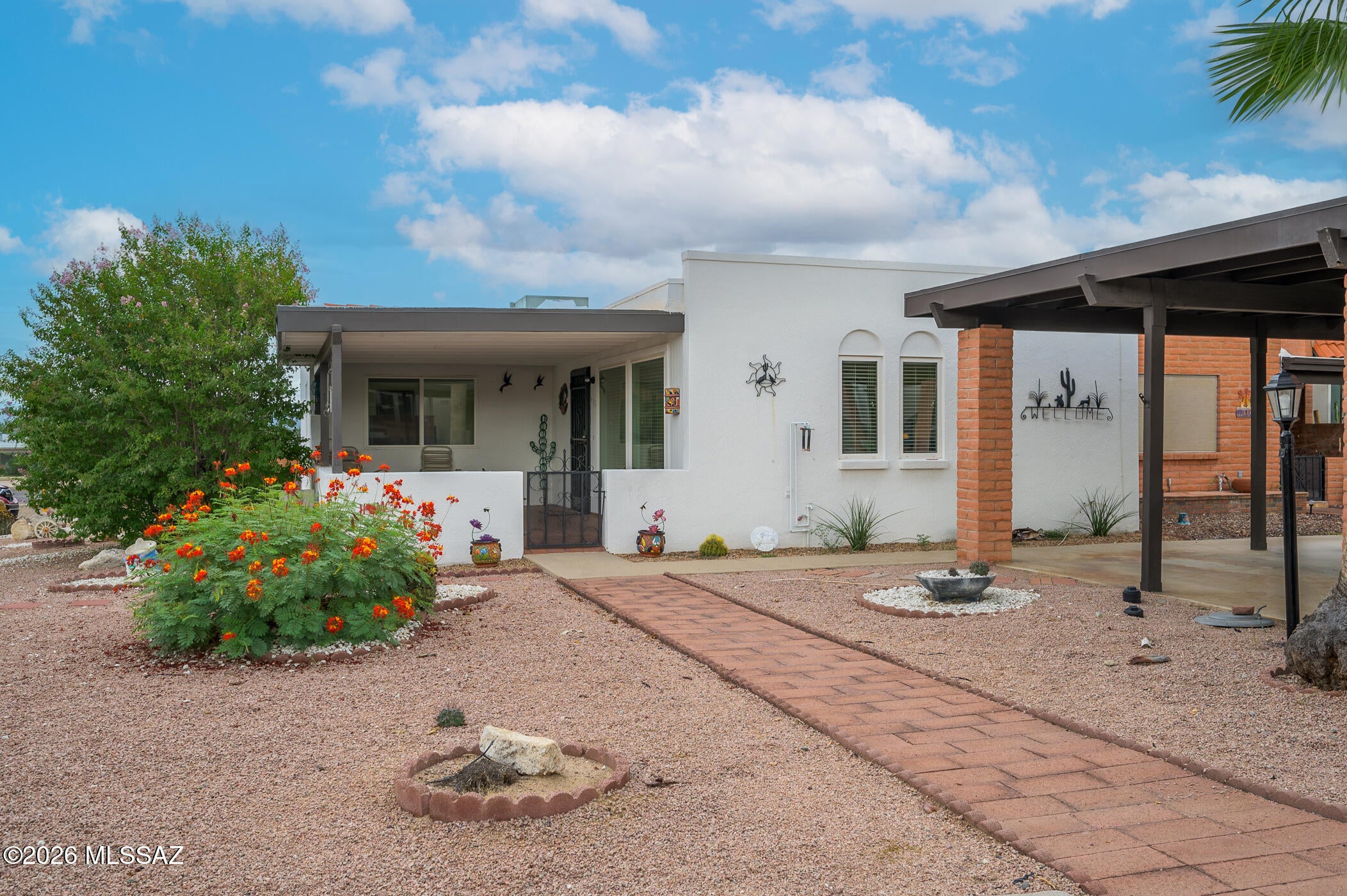 Your charming, Low Maintenance Green Valley Escape is in this 1,326 sq ft townhome in Casa Paloma I offers a functional layout with spacious Arizonia room, an efficient kitchen, and two comfortable bedrooms. Recent improvements include a new roof in 2025, newer interior and exterior paint, dishwasher and range, HVAC serviced twice a year. The front and backyard feature a covered patio and low-maintenance landscaping with covered carport. Located just blocks from the nearest GVR pool and close to shopping, dining, and area amenities. A great option for full-time or seasonal living in Green Valley.
