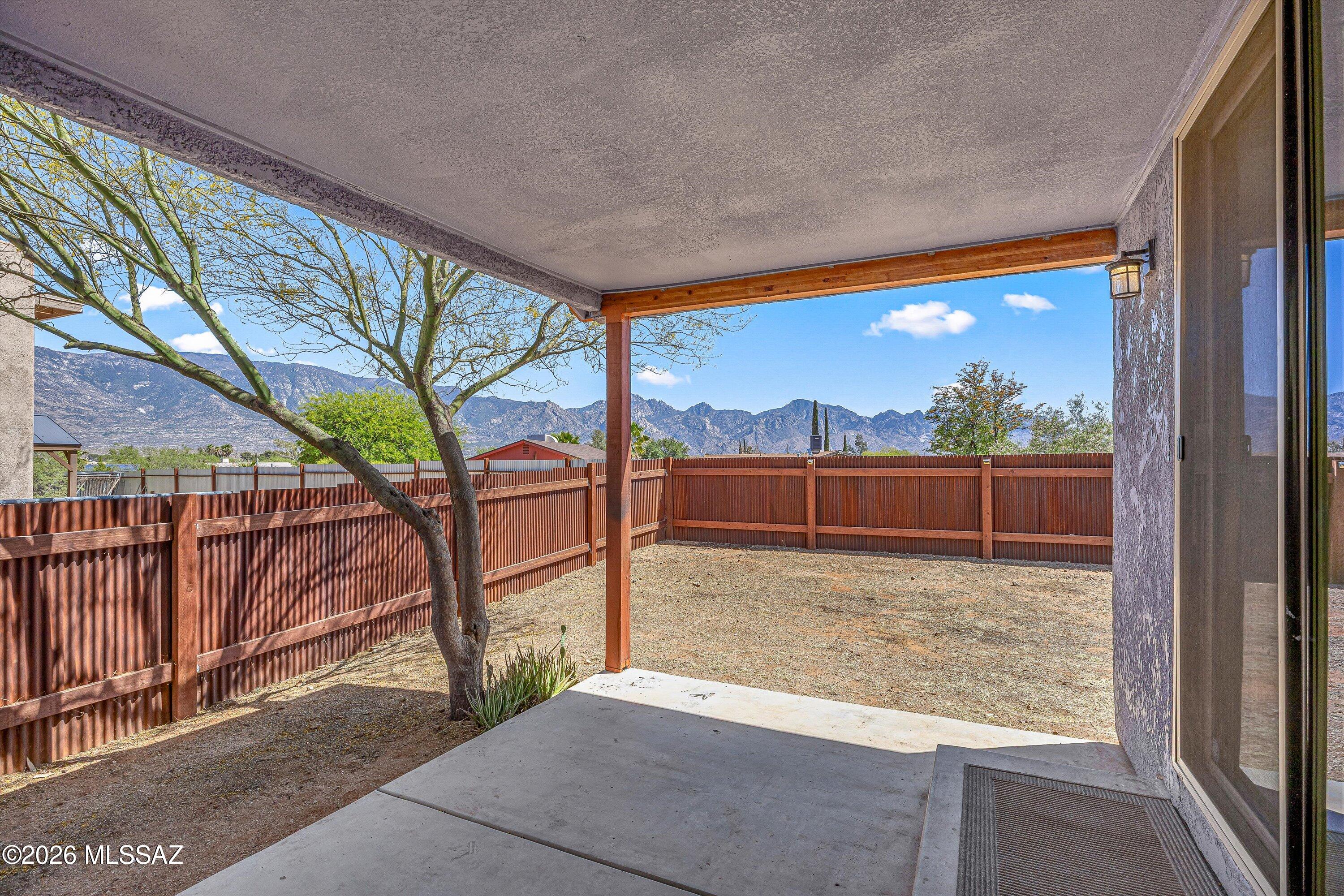 Experience the perfect marriage of vintage soul and modern luxury in this one-of-a-kind sanctuary. At its heart lies a charming 1950s residence, moved and seamlessly blended into a stunning 2020 build. A total surprise upon entry, the bright, open floor plan features original 1950s oak floors, wood beam accents, and natural wood doors. The new kitchen shines with granite countertops, stainless appliances, and a center island, balancing old world character with modern amenities. This split-bedroom home sits on a quiet cul-de-sac and boasts rusted metal garage doors & corrugated metal fencing.  Enjoy spectacular mountain views throughout the home, fenced backyard and covered patio, ideal for entertaining & gathering. No HOA, the possibilities are endless in this inviting, must see home!