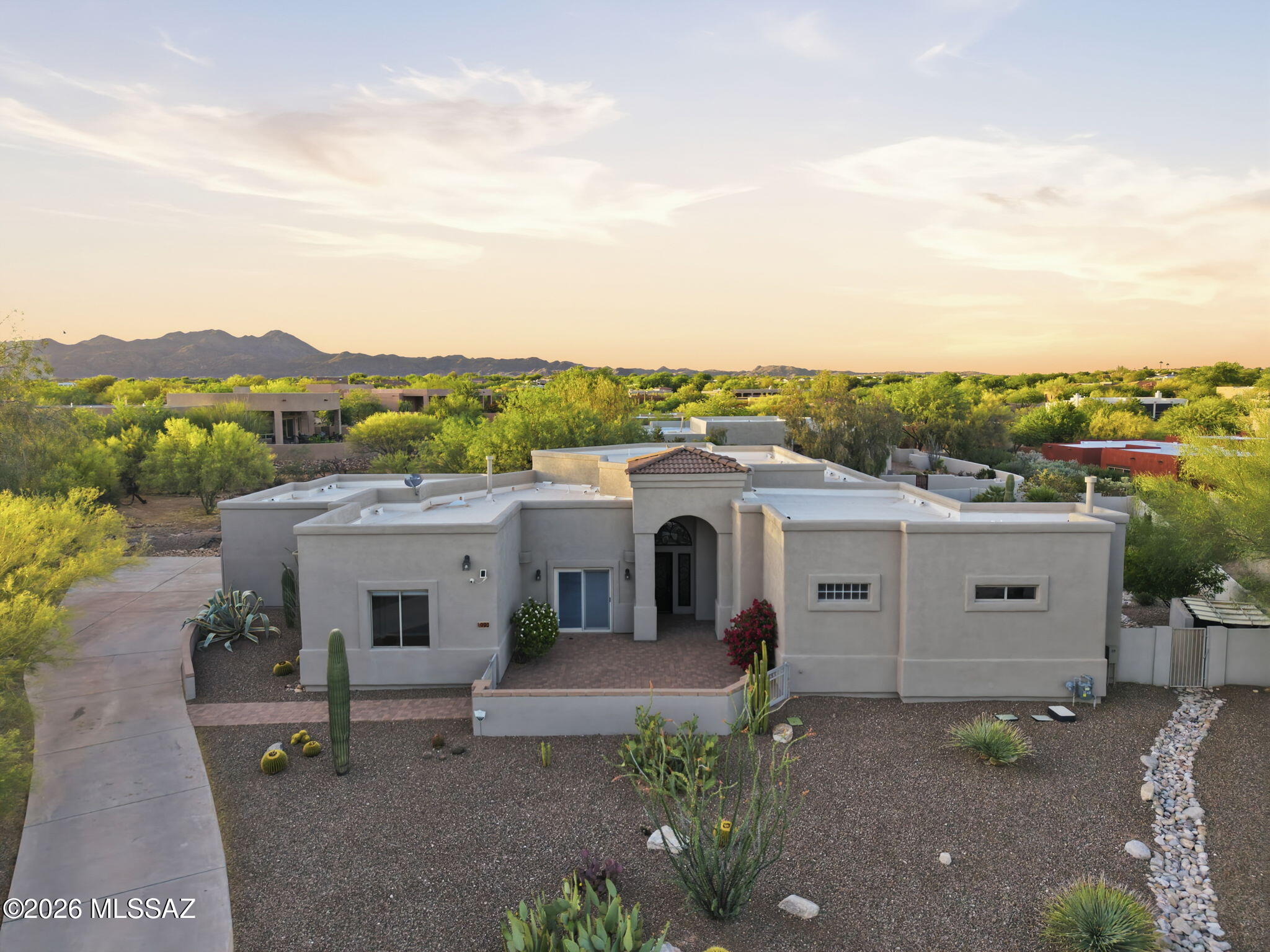 Stunning custom home in heart of Oro Valley. Beautiful, private lot sits on a cul-de-sac w/backyard east facing towards Catalina Mtn range.This home has a remodeled Kitchen w/custom maple cabinets & range hood, large Island, SS appliances, wine fridge, quartz counters, custom backsplash w/new recessed lighting throughout. Kitchen also offers eat-in Nook & Dining area w/direct views towards mtns through large picture windows. Picture windows host gorgeous views plus custom auto blinds. Beautiful custom iron front door w/metal screen allows light to fill space. New Paint inside 2022, outside in 2024; New water Heater in 2023; New carpet 2024. Custom built-in office furniture through French doors. Split FP w/primary bedroom hosting auto blinds, large walk-in closet & separate spa tub & shower Resort-style backyard w/pebble-tec pool, water feature, outdoor kitchen, covered patio & fire pit--perfect for Arizona sunsets.