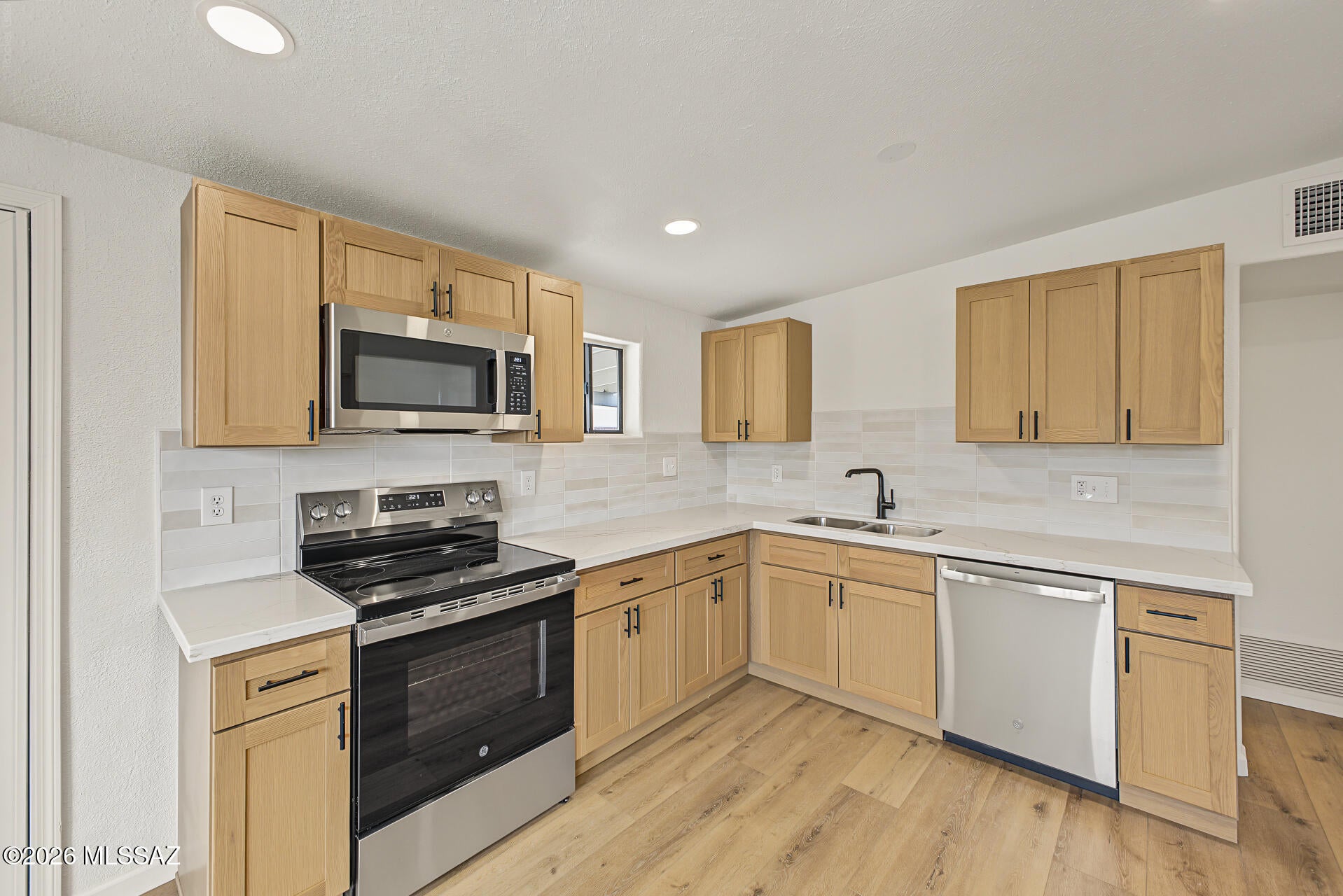 Move-in ready home situated on a large corner lot! Featuring beautiful wood-look luxury plank flooring, plush carpet, modern lighting and plumbing fixtures, and fresh interior and exterior paint. The inviting kitchen showcases Quartz countertops, natural brown cabinetry, stainless steel appliances, and a trendy tile backsplash. Stylish tile shower surrounds add a modern touch to the bathrooms. Spacious lot offers plenty of room to enjoy the outdoors. A must see!