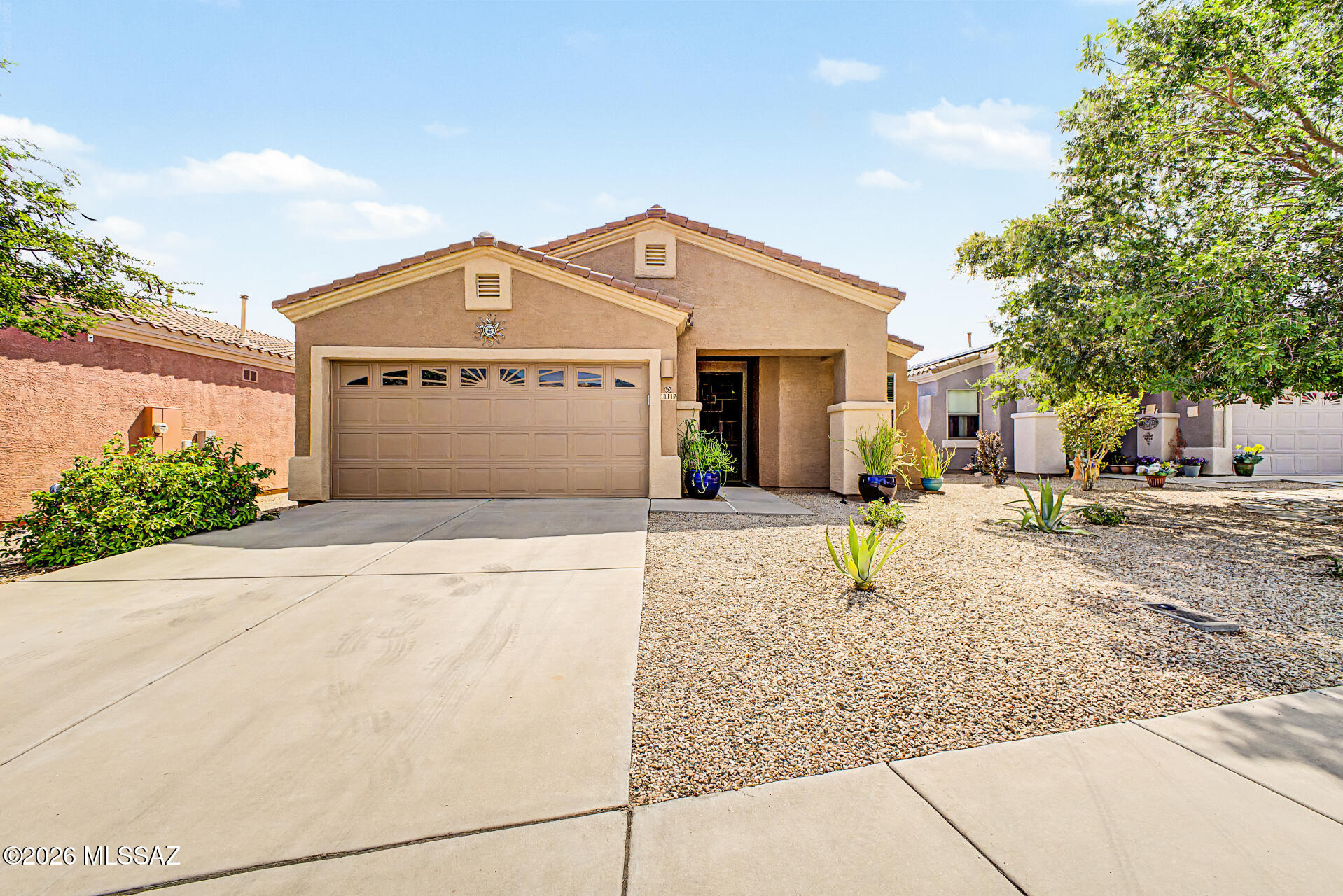 Nestled in an unbeatable location, Rams Pass offers the perfect blend of everyday convenience and outdoor adventure. Exclusive neighborhood park located in the subdivision. With Catalina State Park just moments away, you'll have easy access to breathtaking desert landscapes, scenic hiking trails, and unforgettable mountain views right outside your door. Whether you're exploring miles of hiking, biking, or walking trails, enjoying a round of golf, or discovering the beauty of the Sonoran Desert, there's always a new adventure waiting nearby. 

This home is beautifully maintained, move-in-ready featuring an inviting layout, stylish finishes, and thoughtfully designed living spaces. Designed with 1,759 sq ft and featuring 3 bedrooms, 2 bathrooms, a versatile den, a 2-car garage with epoxy flooring, and low-maintenance landscaping- this home is designed for easy everyday living.

Step inside to an inviting foyer leading to a spacious great room, thoughtfully designed for both everyday living and effortless entertaining. Beautiful tile flooring flows throughout the home, complemented by a neutral color palette that enhances the bright, open feel and offers the perfect canvas to make this home your own.

The gorgeous kitchen offers abundant cabinetry with crown moulding, granite countertops, SS appliances, a gas stovetop/oven, a striking stacked-stone backsplash, recessed lighting, and a two-tier peninsula with a breakfast bar, perfect for casual meals or gatherings with family and friends.

French doors open to a versatile den, ideal for a home office, media room, or flex space. The spacious primary bedroom offers two walk-in closets, and an en-suite bathroom complete with dual vanities with a shower/tub combo for added comfort and convenience. The remaining bedrooms are ample size and share the hallway bathroom. 

Escape to your own private outdoor setting, where green space is directly behind and added privacy creates a peaceful ambiance. The extended full-length covered patio is perfect for hosting gatherings or enjoying quiet evenings, while the artificial turf and beautifully laid paver walkways offer both style and low-maintenance living. Breathtaking mountain views provide the perfect finishing touch to this exceptional backyard. 

You're not just finding a home, you're embracing a lifestyle where nature, recreation, and convenience come together in one exceptional location. When it's time to unwind, you'll appreciate the community's close proximity to shopping, restaurants, medical facilities, and other everyday conveniences, making life as easy as it is exciting. Don't let this gem slip away!