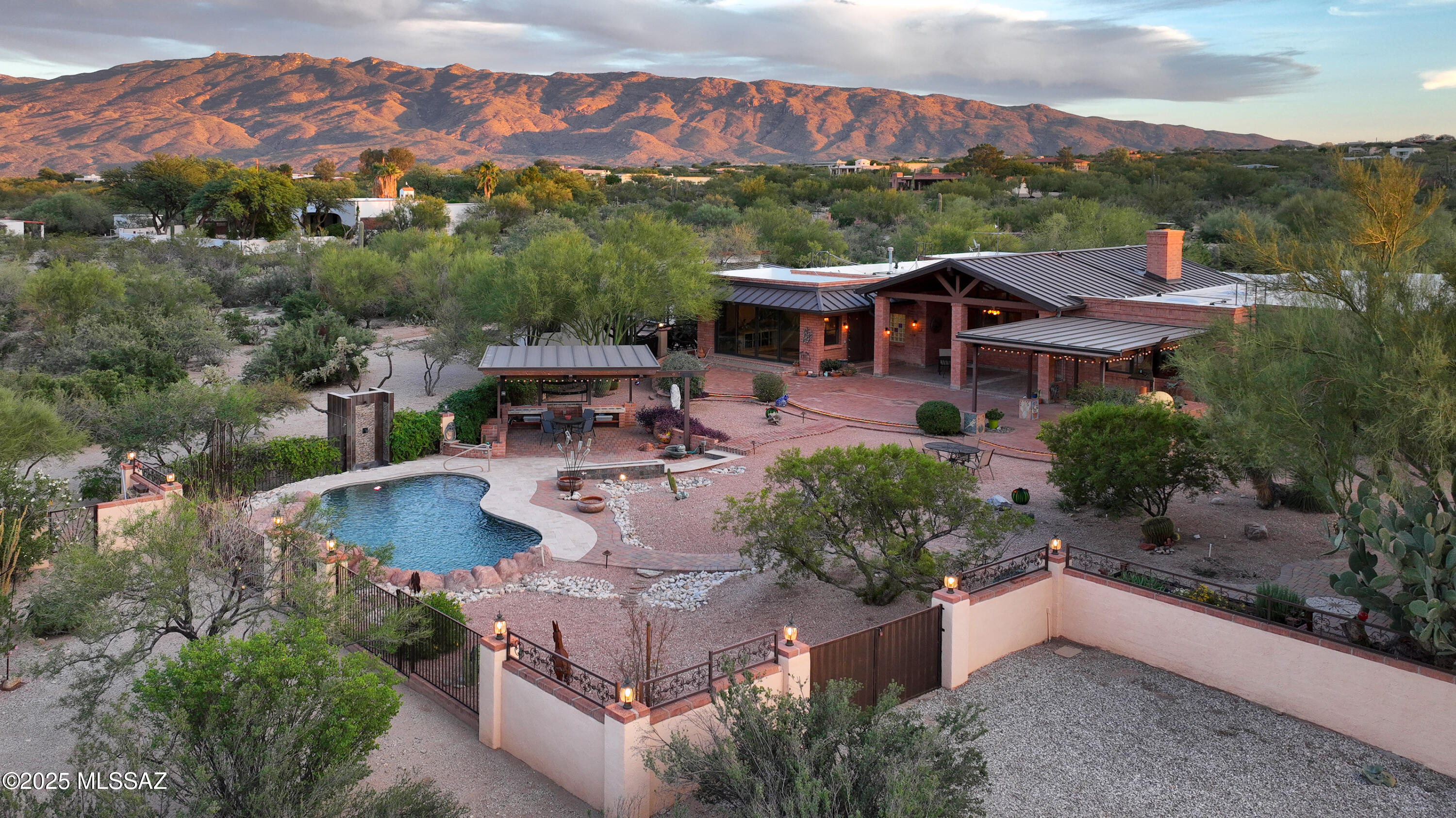 Incredible views of the Catalina & Rincon Mtns on 3.3 acres. Southwest style home showcases quality craftsmanship & decorative finishes. 2 Owners' Suite's each with private sitting room & full baths, plus 2 add'l bedrooms & baths. Kitchen has alder cabinets, custom hardware, double ovens, 2 stovetops & more. Spacious office with private entry.  Oversized 3-car garage with laundry & large storage room. Backyard, an entertainer's dream with a sparkling pool, poolside ramada, outdoor shower, covered patios, pizza oven and garden shed. Beyond the enclosed yard, discover an Artist Studio & Workshop/4th Garage. Near Saguaro National Monument East & Agua Caliente Park, golf, hiking & biking.Tanque Verde Schools. Low HOA.