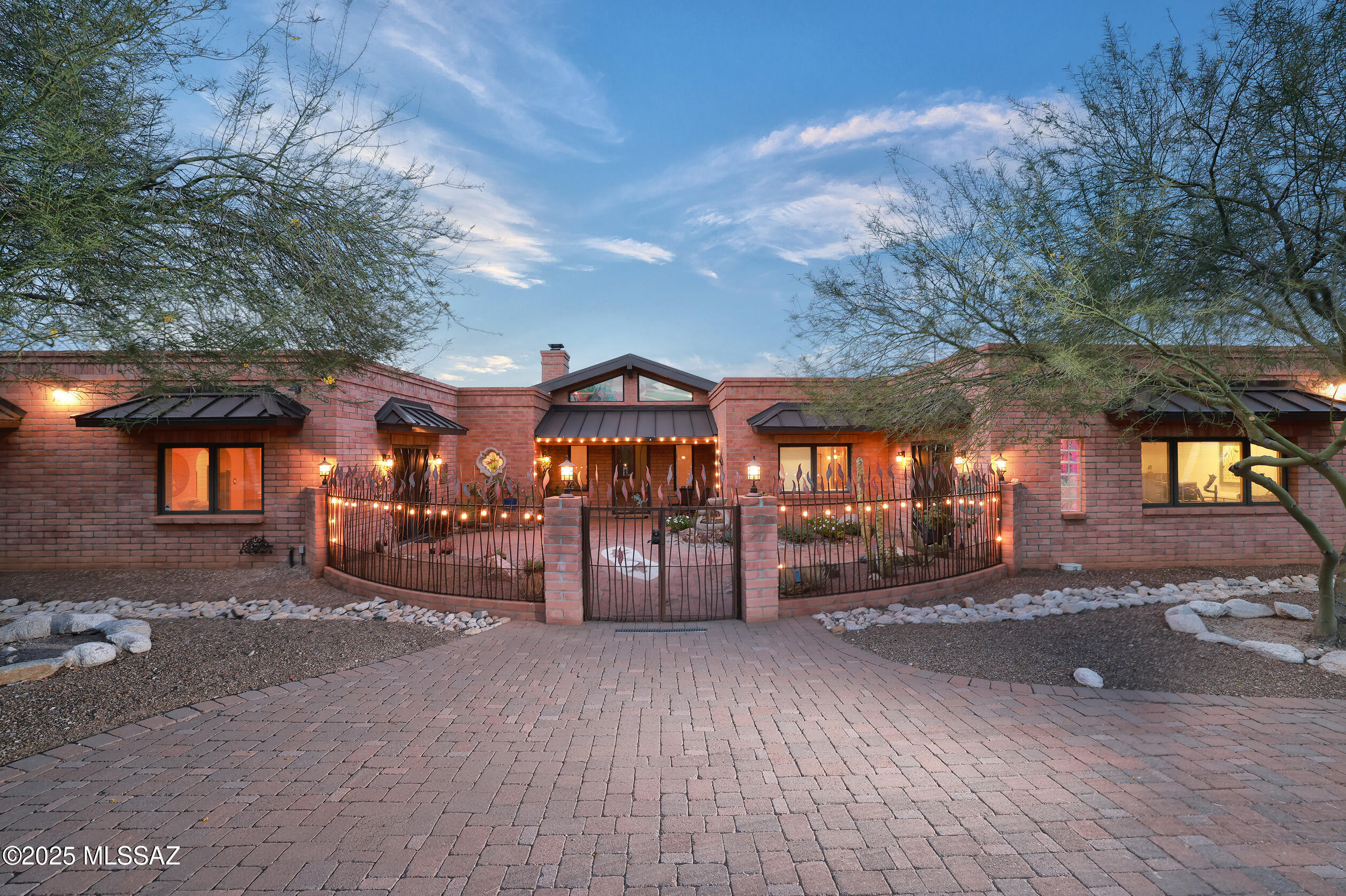 Incredible views of the Catalina & Rincon Mtns on 3.3 acres. Southwest style home showcases quality craftsmanship & decorative finishes. 2 Owners' Suite's each with private sitting room & full baths, plus 2 add'l bedrooms & baths. Kitchen has alder cabinets, custom hardware, double ovens, 2 stovetops & more. Spacious office with private entry.  Oversized 3-car garage with laundry & large storage room. Backyard, an entertainer's dream with a sparkling pool, poolside ramada, outdoor shower, covered patios, pizza oven and garden shed. Beyond the enclosed yard, discover an Artist Studio & Workshop/4th Garage. Near Saguaro National Monument East & Agua Caliente Park, golf, hiking & biking.Tanque Verde Schools. Low HOA.