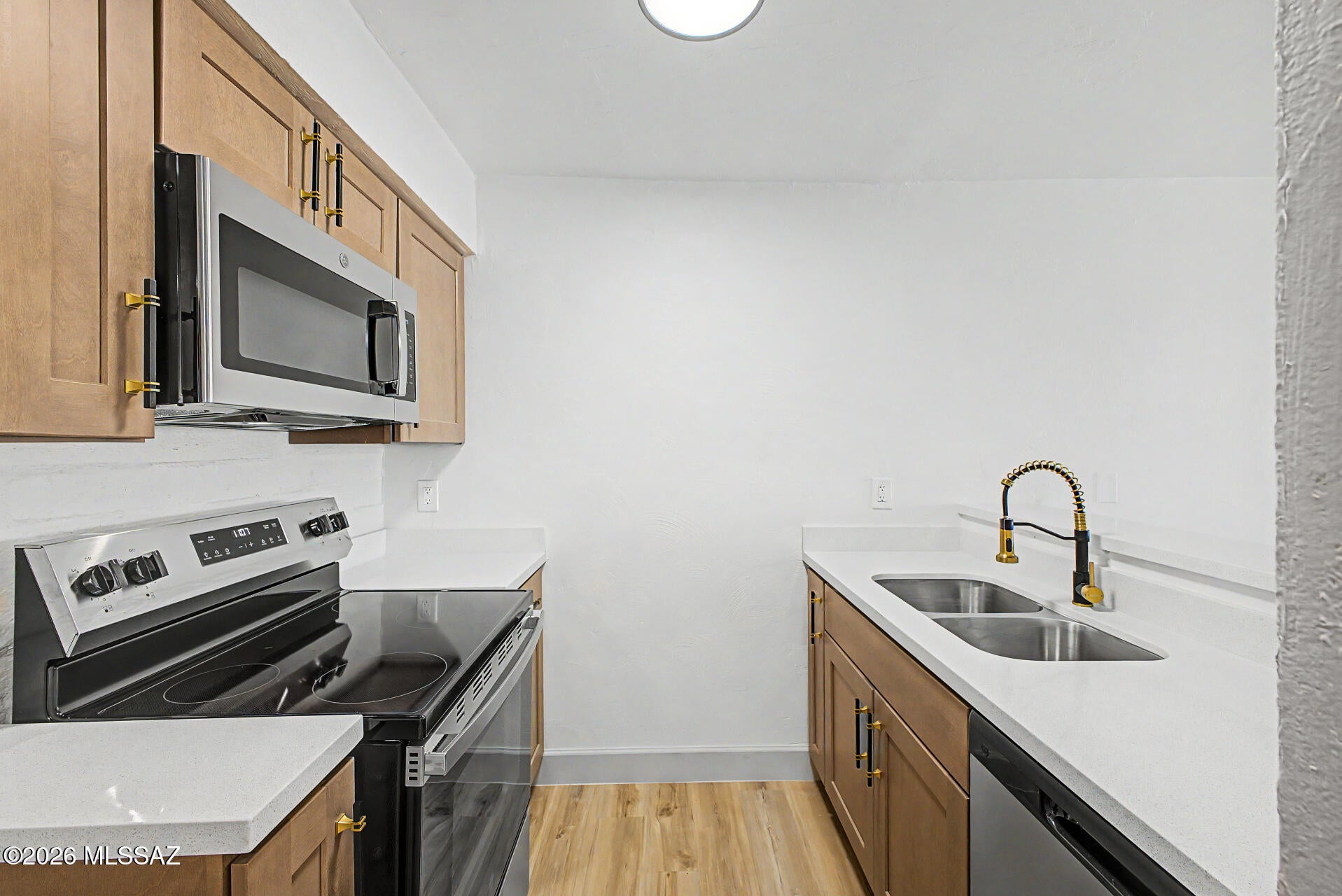 MOVE IN READY NEAR THE U OF A! This beautifully remodeled 2 bedroom, 1.5 bath Campus Walk condo offers 1,086 sq ft of stylish living just minutes from the University of Arizona and Main Gate Square. Step inside to fresh two tone paint, new LVP flooring, baseboards, lighting, ceiling fans and updated hardware throughout. The gorgeous kitchen features soft close cabinetry, quartz countertops, an undermount sink, breakfast bar and new stainless steel appliances. Both baths have been beautifully updated, including a dual sink vanity with undermount sinks downstairs. Relax on your private balcony or enjoy the community pool, study lounge, pool table and onsite laundry. HOA includes common area maintenance, pest control, roof repair and replacement, water and much more. A MUST SEE!