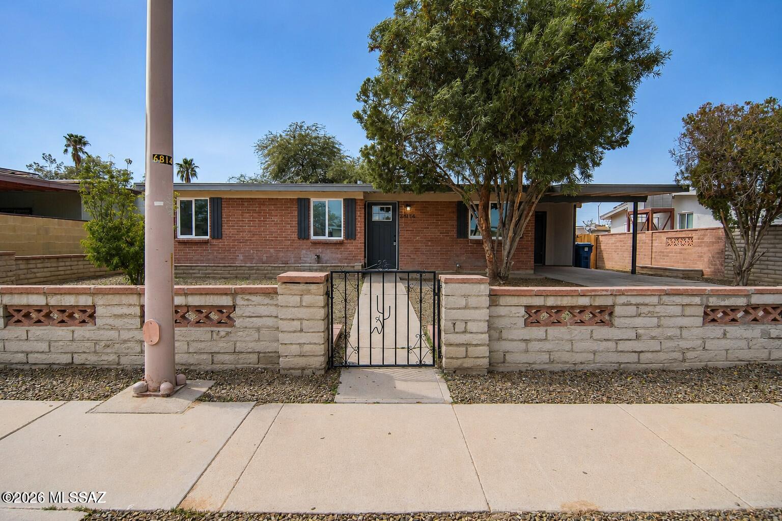 Beautifully remodeled Ranch style home. Located in a convenient South Tucson location. Charming brick construction. Rich wood look LVP flooring. Updated modern kitchen. New Stainless steel appliances (dishwasher, stove, microwave),  to be installed. New custom interior and exterior paint. Updated bathrooms. Ceiling fans in living room. Fenced yard. Mature trees. Upgraded door hardware and light fixtures. New dual pane windows. New HVAC and water heater. One car carport. No HOA. This home shows beautifully.