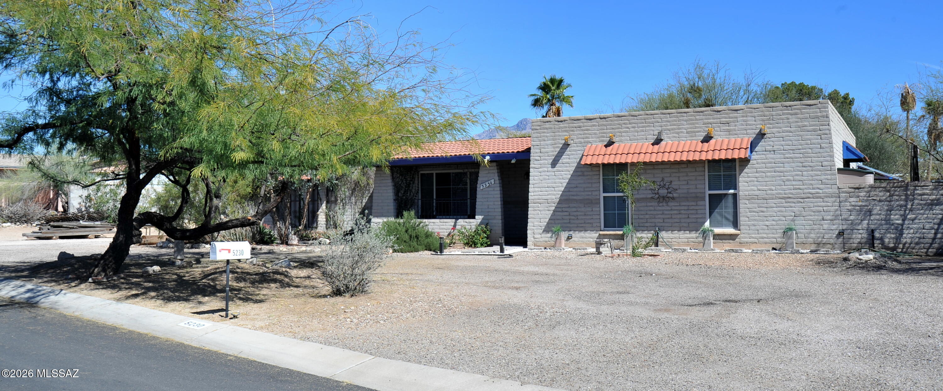 This expansive 4-bedroom, 2-bathroom  residence spans approximately 1,620 square feet and combines a functional layout with timeless Arizona architecture.   A bright, open kitchen  Bonus Arizona Room An enclosed space with dedicated window A/C, perfect for a home office or hobby room. Flexible Layout Four bedrooms provide ample space for families or guests. Includes a dedicated laundry room and a 2-car garage. A storage room off the garage and a 2nd workroom in the backyard.  Situated on approximately 0.42 acres with a  backyard full of fruit trees, covered patio, and slump block fencing. Iconic Tucson scenery and desert vistas. Located in the Casas Adobes area, minutes from the River Road corridor, La Encantada shopping, and local dining.