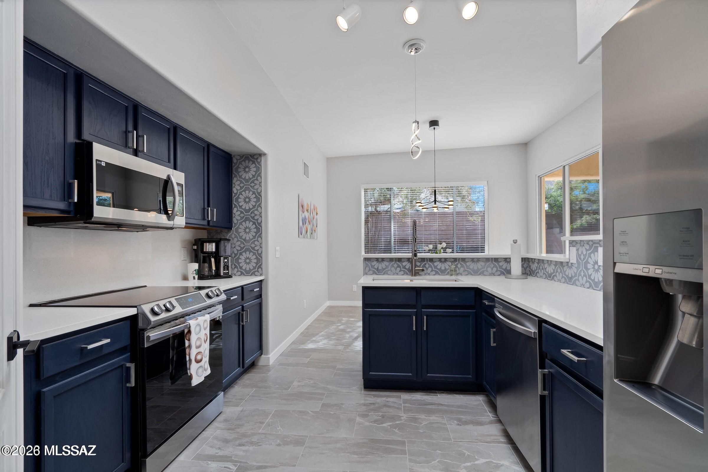 Welcome home to this beautiful 3 bdr/2ba home in the highly desirable Wrightstown Ranch community on Tucson's Eastside. Featuring an open and functional split-bedroom floor plan, this home offers comfortable living spaces filled with natural light. The stylish kitchen offers Quartz counters, stainless steel appliances, a tiled backsplash, and sleek cabinetry that complements the home's contemporary design.
The spacious primary bedroom includes a private ensuite with dual vanities and a beautifully tiled walk-in shower. 
Neutral grey tones and thoughtful finishes create a clean, inviting atmosphere that is move-in ready.
Step outside to enjoy a low-maintenance backyard with room for relaxing or hosting family and friends.