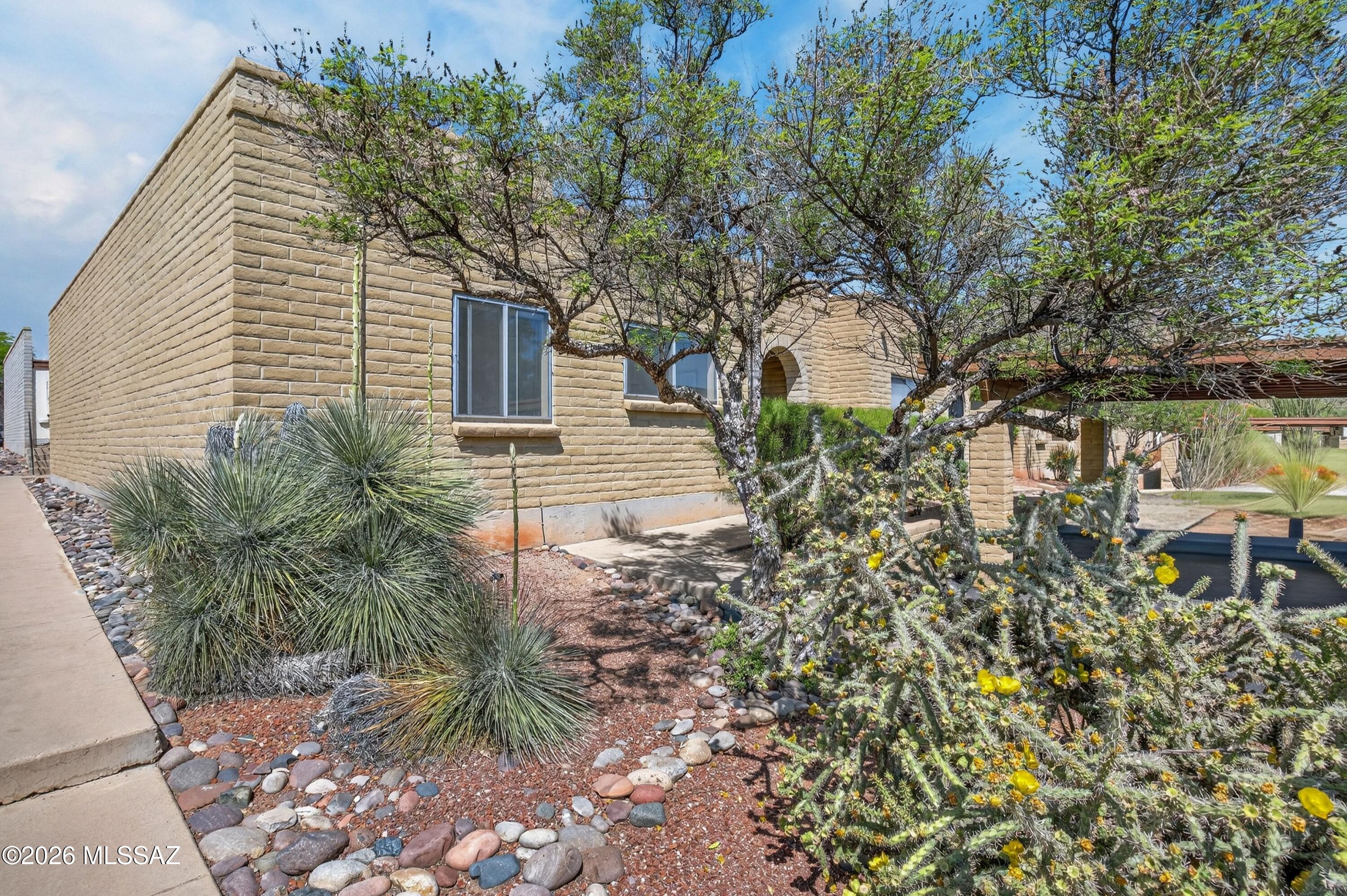 Price Reduced. Beautifully renovated three bedroom two bathroom end unit townhome just outside the Starr Pass community. Convenient to downtown Tucson, Mercado San Augustin, Raytheon and Tucson International Airport. Recent updates include carpet, ceramic tile and laminate flooring, kitchen with newer stainless steel appliances, modern cabinetry and counter tops, bathroom vanities, brushed nickel fixtures , newer roof, serviced HVAC, recently added back patio cover and wood fence. Community pool. Two car carport, one covered space, one uncovered space. HOA covers common area maintenance, front yard maintenance, roof repair, sewer, water and community pool.