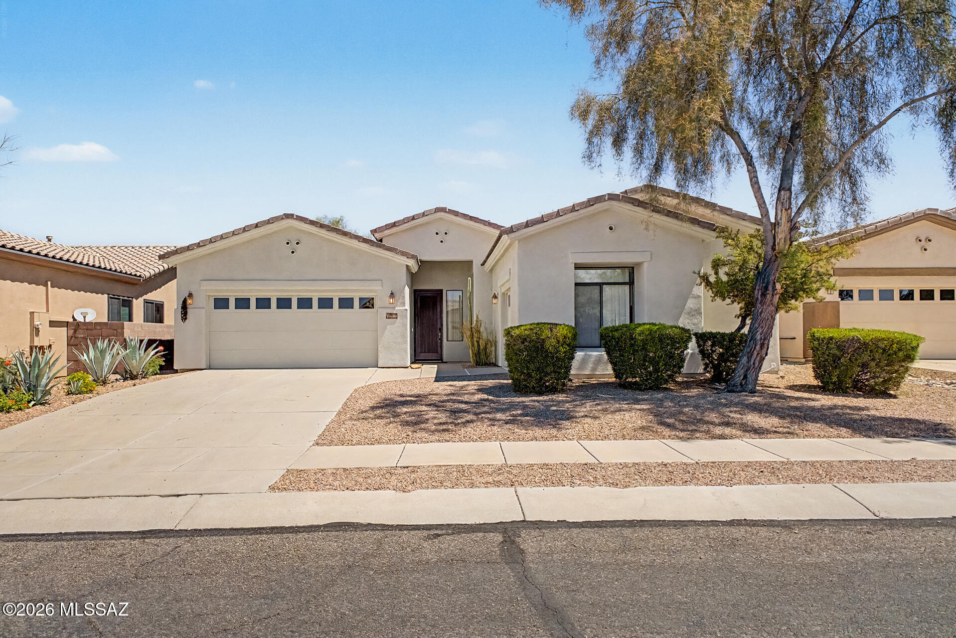 This fully furnished turnkey home awaits you in The Bluffs At Dove Mountain! Offering 3 beds, 2 baths, 3-car garage and a well-manicured landscape. The inviting interior features tons of natural light, a designer palette, and tile flooring in all the right places. You'll love the spacious, seamlessly flowing open layout paired with a fireplace! The kitchen boasts built-in appliances w/cooktop gas, tile counters, a pantry, recessed lighting, wood cabinetry w/crown molding, and a 2-tier peninsula w/breakfast bar. The sizable carpeted main bedroom has a bay window, sliding doors to the back and an ensuite with dual vanities, a separate tub/shower, & a walk-in closet. Tranquility awaits in the large backyard! A covered patio, artificial turf and shade trees complete this desert masterpiece.