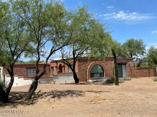 Furnished country home is located in the desirable Tubac Valley Country Club Estates. Enter into a front courtyard into a large living room, which flows into a dining area and family room. Interior features include exposed beam ceilings, fireplace, tile flooring, a large kitchen with custom cabinets, an oversized granite island and stainless-steel appliances.  Primary bedroom has direct access to another courtyard, dual walk-in closets and bath with dual sinks and walk-in shower.  Split-floor plan with second bedroom and custom tiled bath.