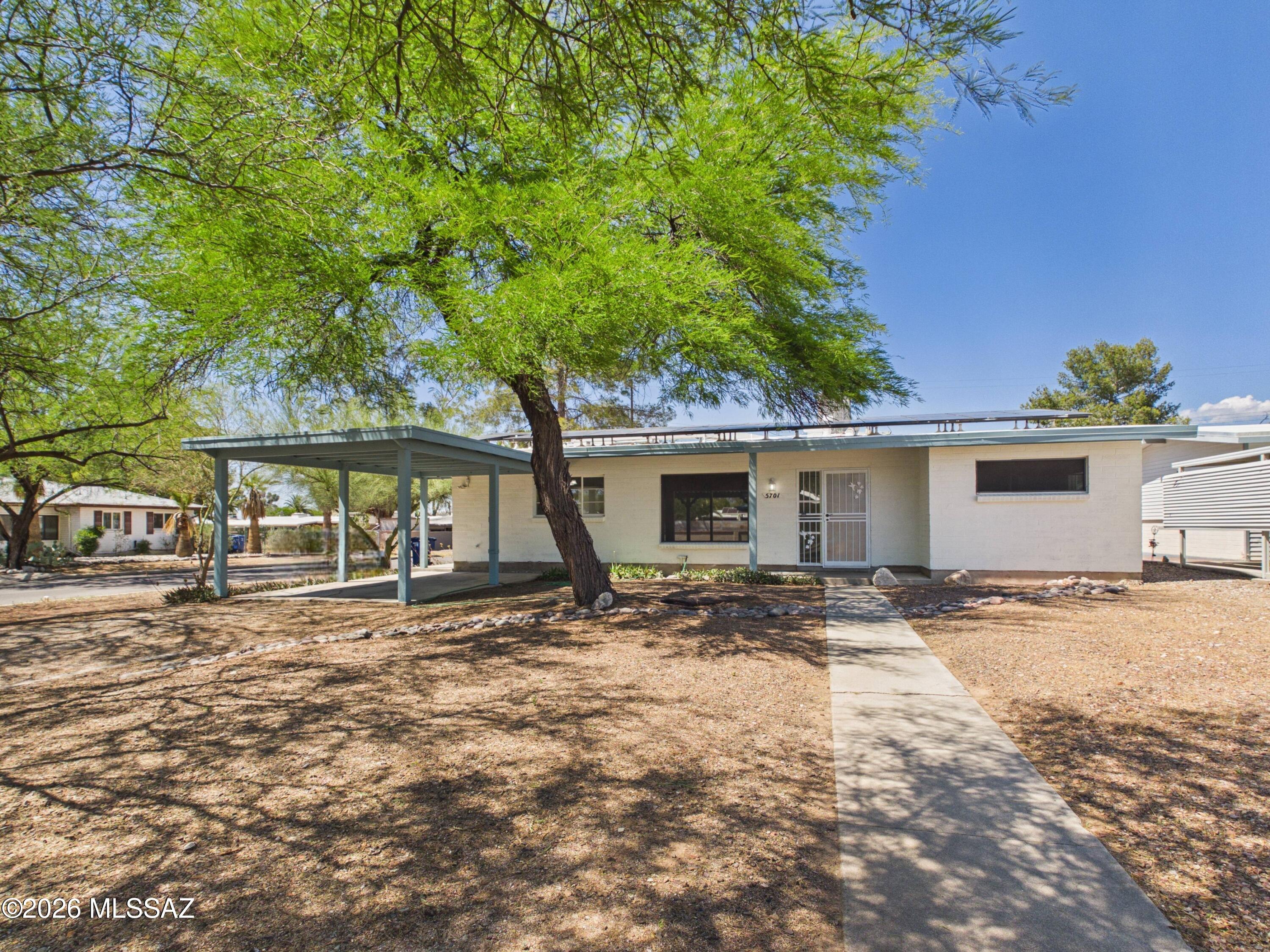 Tucked beneath the shade of mature trees, this inviting home blends warmth, charm, and thoughtful updates in all the right ways.
Inside, you'll find 3 bedrooms, 2 bathrooms, a beautifully remodeled kitchen with quartz countertops, fresh new carpet in the bedrooms, and a brand-new HVAC system for added comfort and peace of mind. The separate guest house offers endless possibilities -- perfect for visitors, extended family, a home office, or extra income potential.
Conveniently located just 6 minutes from TMC Hospital and only minutes from shopping, dining, and entertainment, this home offers both comfort and convenience in a central Tucson location.
With no HOA and plenty of space to make your own, this home offers  comfort and flexibility.