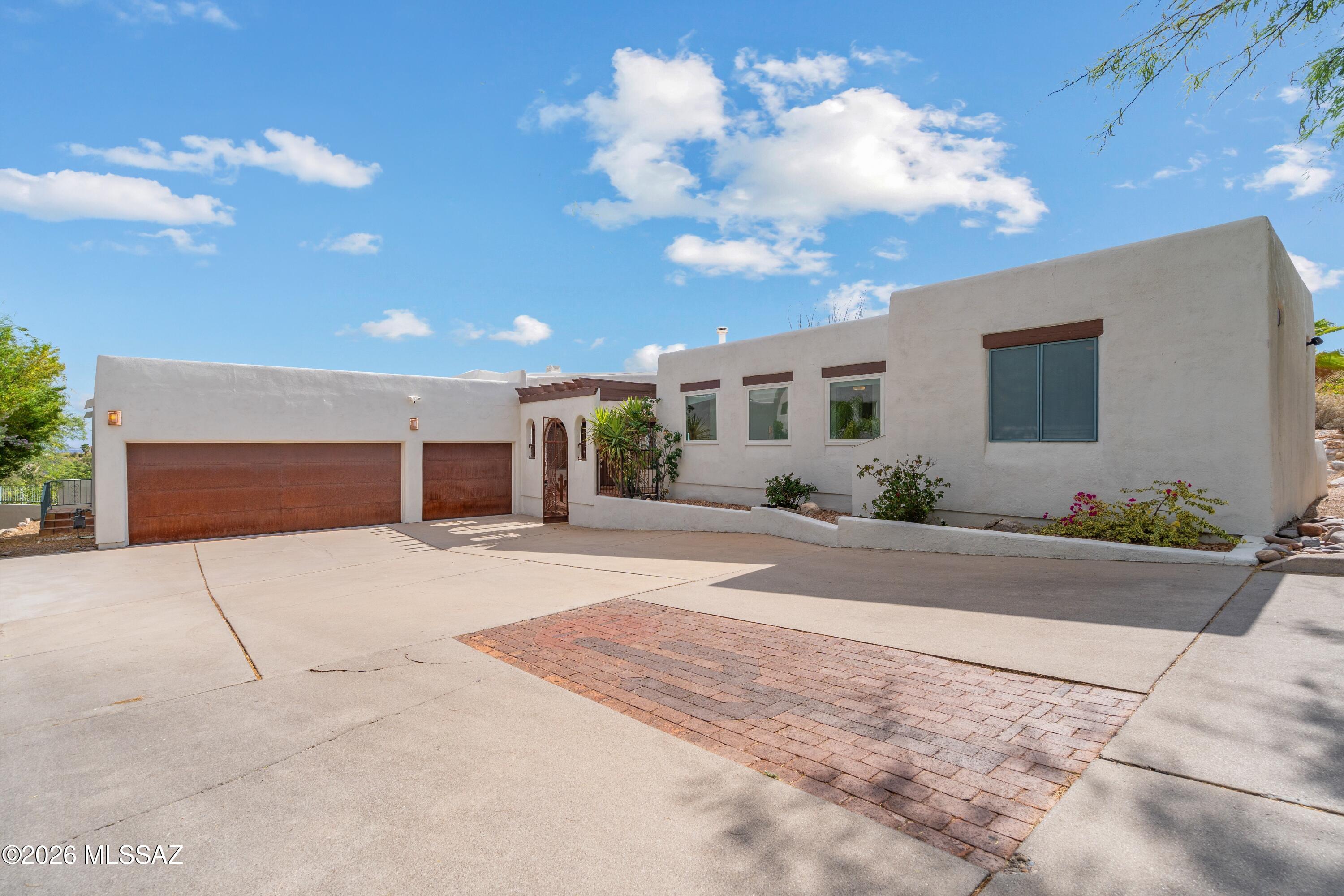 Seller will accept or counter offers between $1250,000-$1,300,00. Nestled in the prestigious Regal Manor Estates of the Catalina Foothills, this updated 3,324 sq ft residence offers 5 bdrms, 3 bathrooms, lg separate family room, sparkling pool & 3 car garage - all framed by sweeping mountain & city views. Basketball court on premises. SELLER OWNED SOLAR Every corner of this home has been thoughtfully updated. The custom kitchen features new cabinetry, SS appliances & granite countertops. New Electrical Panel, new hot- water heater, new EcoWater softener, reverse-osmosis purifier & new LED lighting throughout. Freshly recoated roof w 5 yr warranty. Exterior repainted.  Catalina Foothills District, minutes from shopping and restaurants. Full list of upgrades is under documents.  A must see.