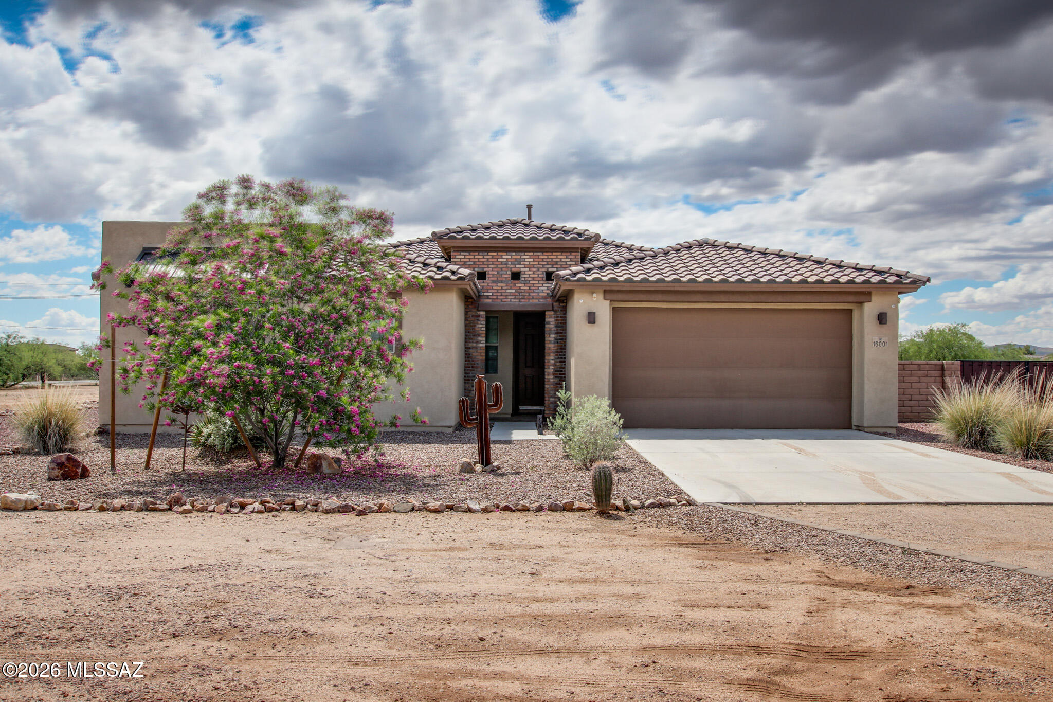 This move-in-ready home combines modern upgrades, generous space, and versatile living in a highly desirable Tucson setting. Built in 2022 on a spacious .80-acre corner lot, this upgraded home combines modern design with functional living. The open-concept floorplan features an oversized stacking, sliding glass door for seamless indoor/outdoor living, a gourmet kitchen with double ovens, two pantries, a large island with ceramic farmhouse sink, and abundant storage throughout. The primary suite offers a large walk-in shower and oversized closet, while 3 of the 4 bedrooms include walk-in closets. A dedicated den/office adds flexibility for work or additional living space.

The expansive backyard is designed for entertaining with an extended covered patio, turf, pavers, and a separate area ideal for a fire pit or gathering space. With nearly an acre, there is still room to create a custom outdoor retreat, pool, or additional amenities to fit your lifestyle.