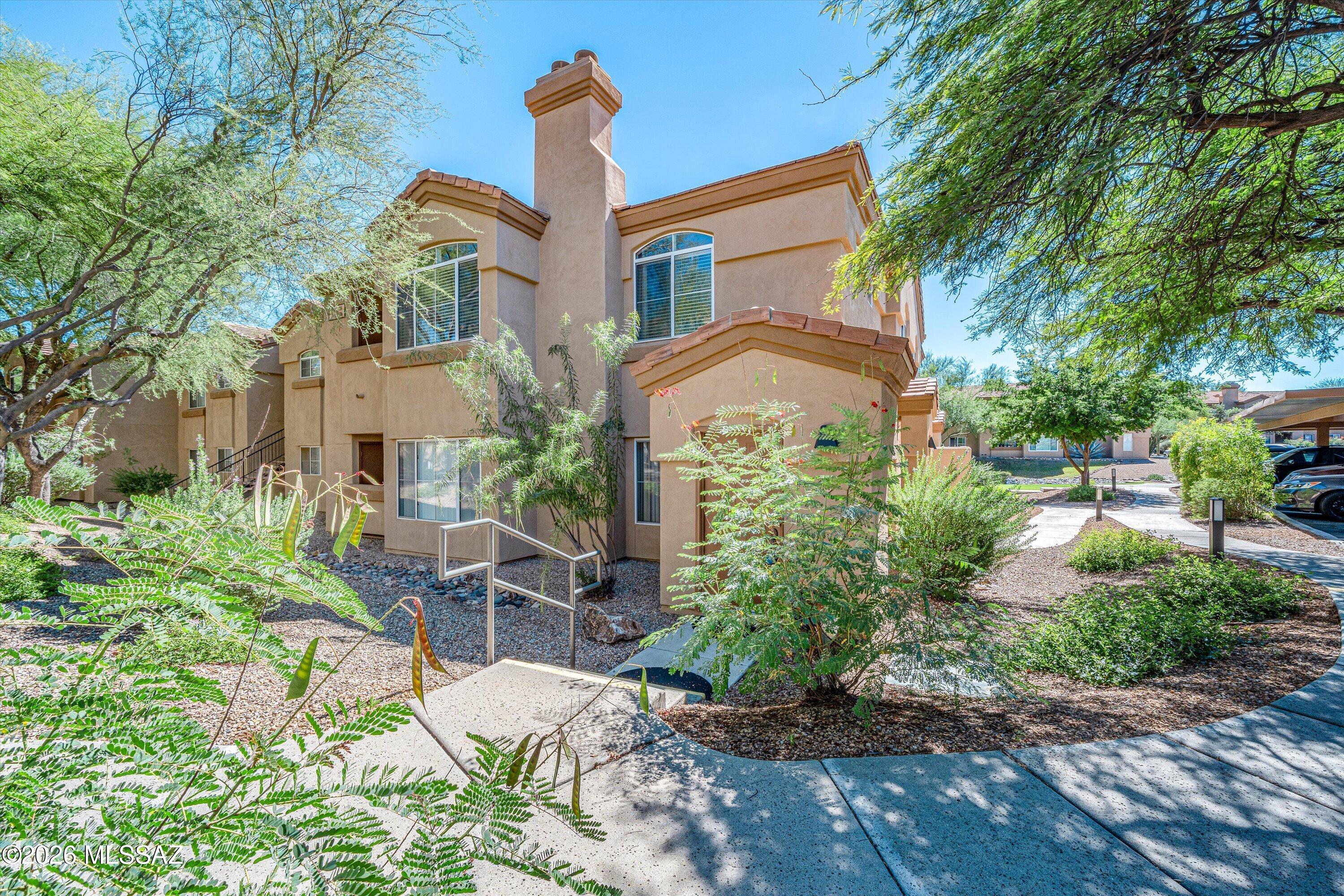 Enjoy resort style amenities in this fully furnished Catalina Foothills condo conveniently located across the street from shopping & numerous restaurants.  This spacious corner unit Northern Tucson property is being sold completely turnkey and features an open floor plan with an abundance of natural light, covered balcony with mountain views & storage closet, cozy wood burning fireplace, split bedroom layout, luxury vinyl flooring, private primary suite with roomy walk-in closet, renovated walk-in shower in guest bathroom, remodeled kitchen with granite counters, dual pane windows, interior staircase and world-class HOA amenities.  The Pinnacle Canyon Condos have a sparkling heated pool & spa, enormous clubhouse with gym, BBQ grills, on site manager and award winning park-like grounds.