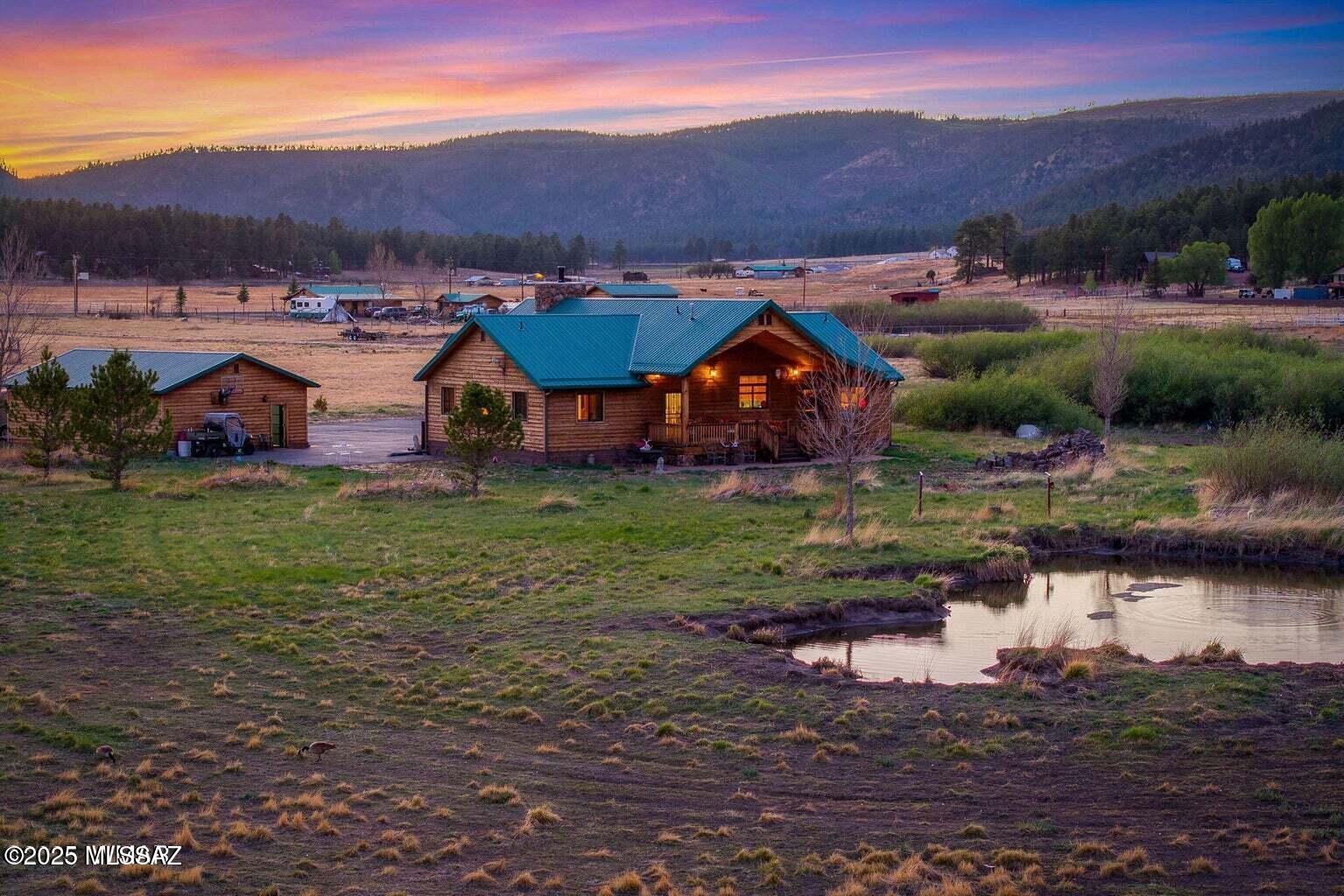 Situated in the heart of Alpine, Arizona, in the beautiful White Mountains, this exceptional 29Â± acre horse property offers the ultimate in privacy, space, and all-season mountain living. A private gated entrance welcomes you to a custom-built, cedar-sided 3-bedroom, 2-bath home designed for comfort and durability, featuring 10-foot walls, vaulted ceilings, a striking floor-to-ceiling John Wayne-style faux rock fireplace, maple hardwood floors, slate in bathrooms and laundry, Berber carpet in bedrooms, and covered redwood decks perfect for taking in the views.